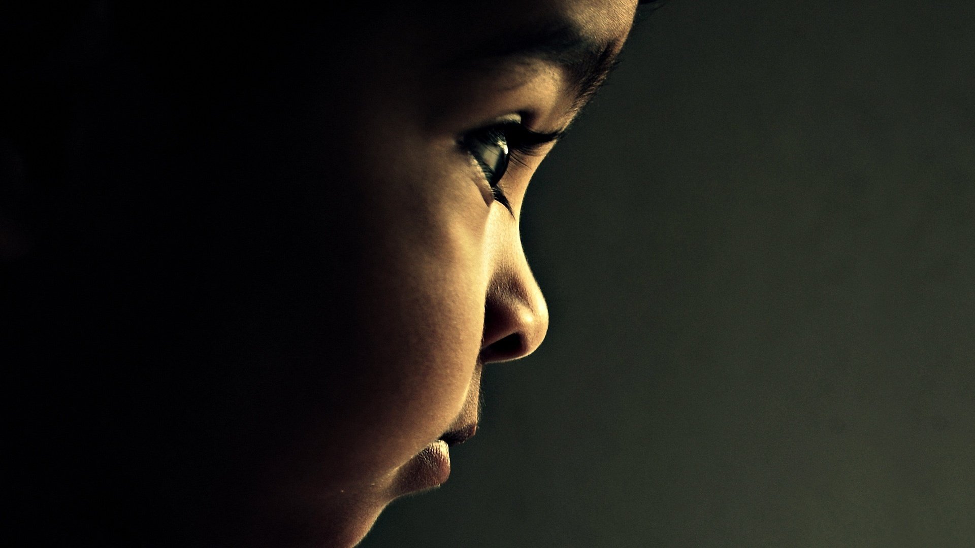 A beautiful baby with dark skin and a snub nose