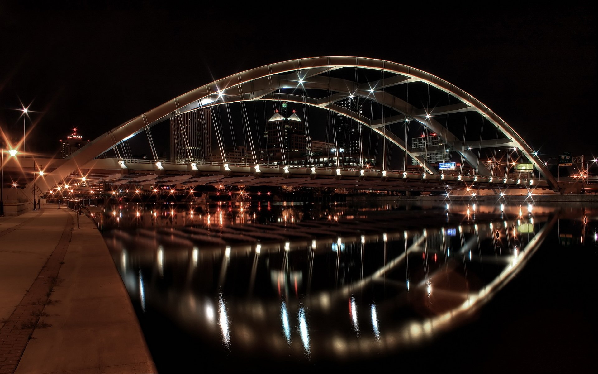 Suspension bridge on the city embankment at night