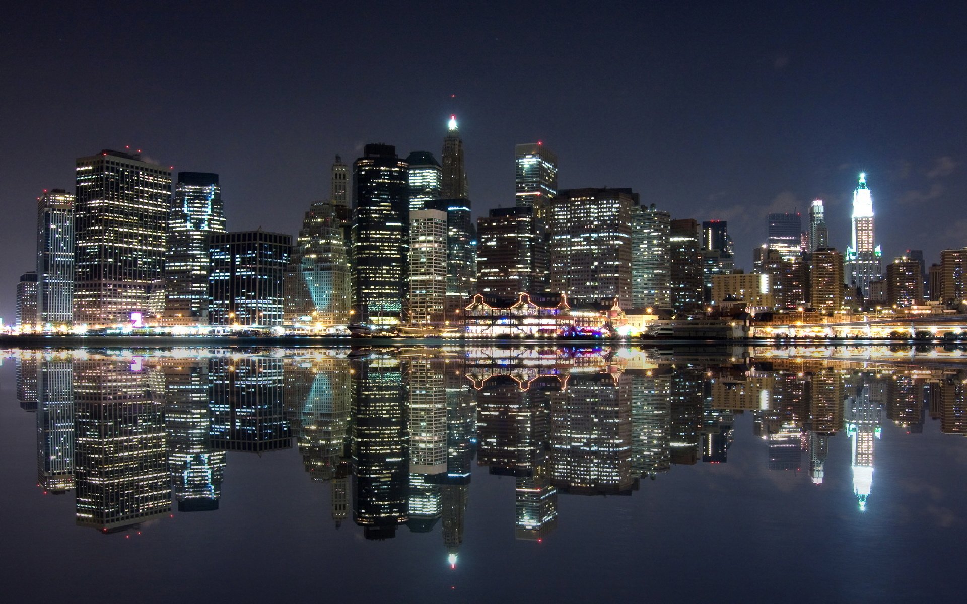 The night metropolis is reflected in the surface of the river