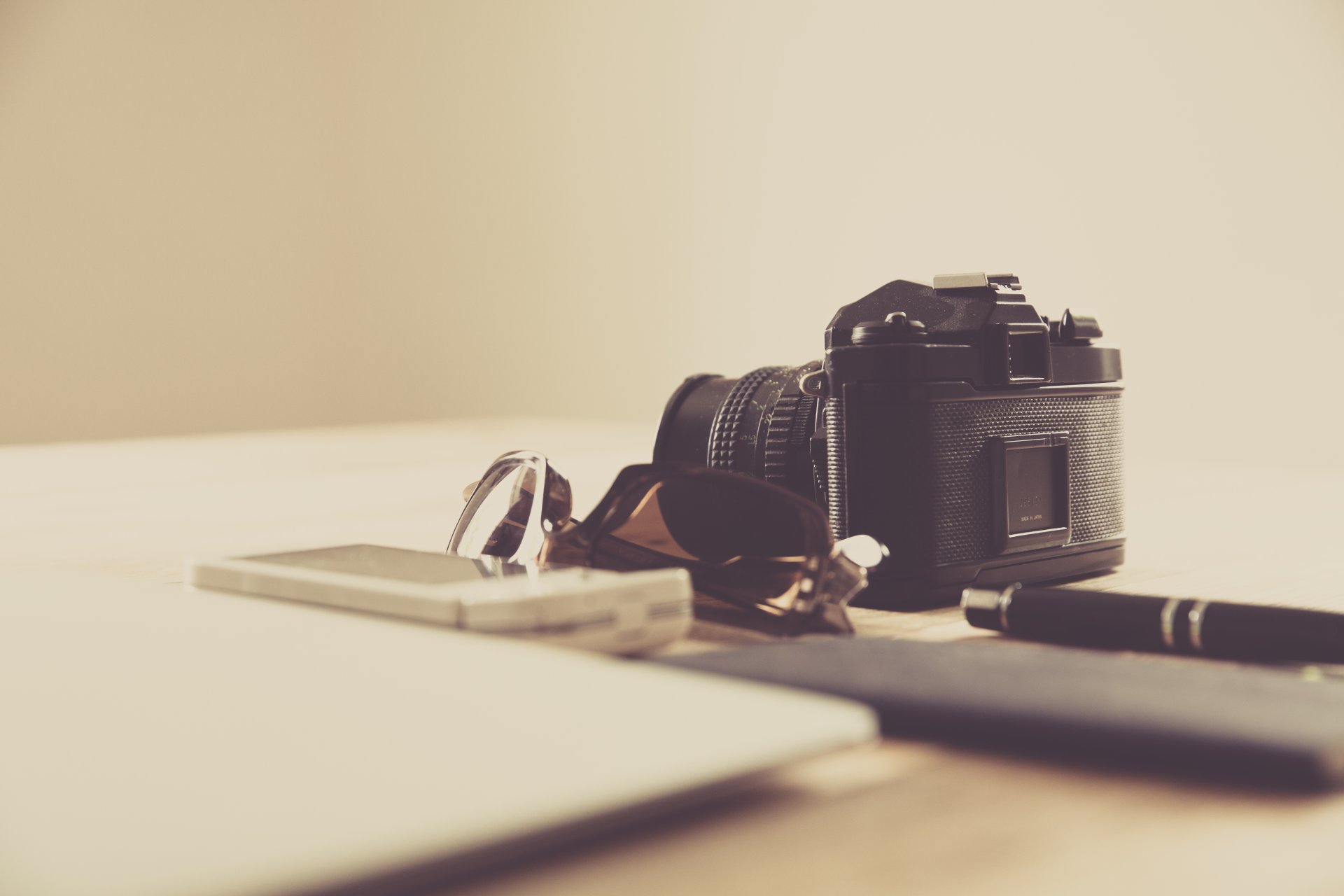 photographer markus spiske photo a camera sunglasses smartphone pen