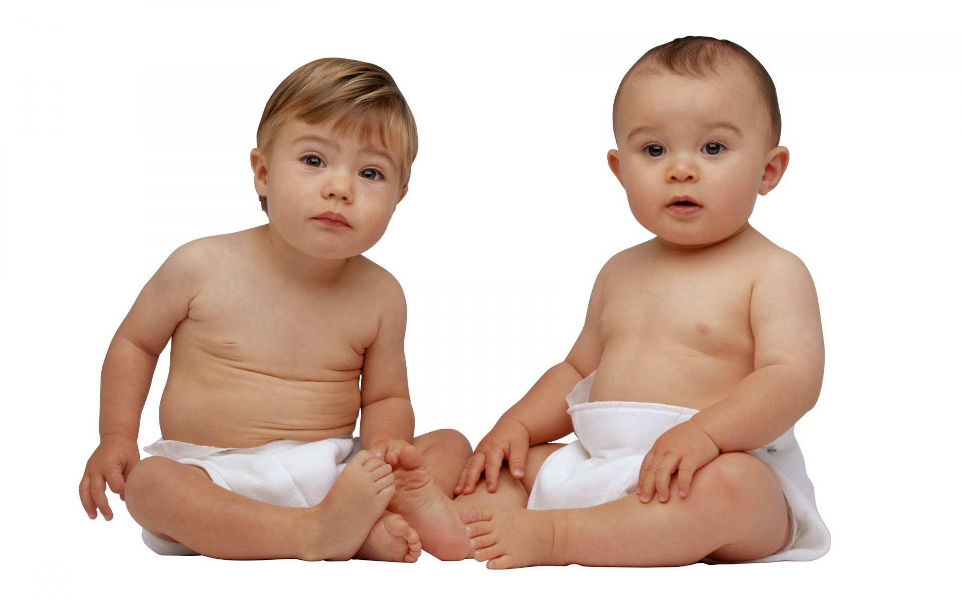 Two babies in diapers are watching carefully