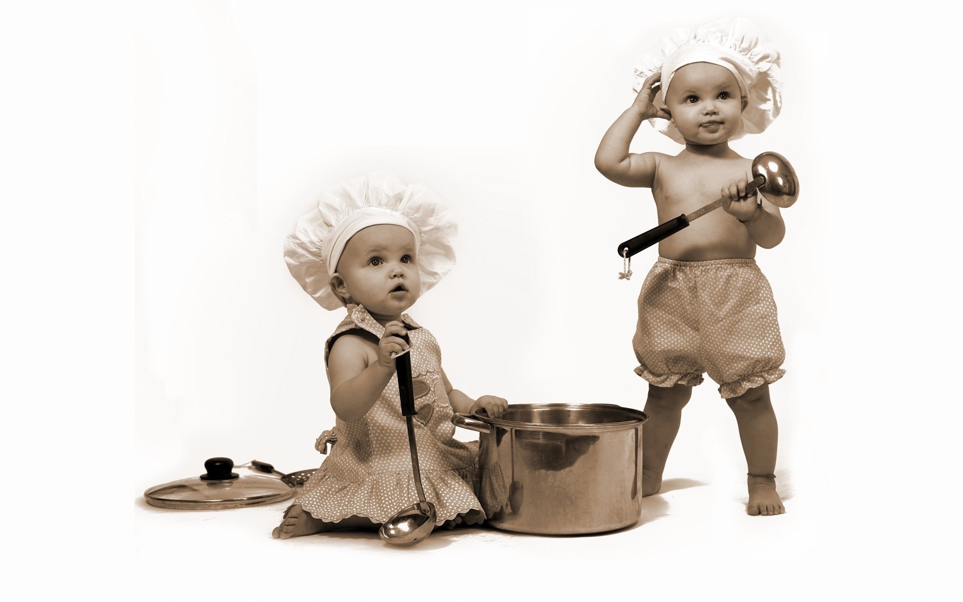 Little cooks with a saucepan and ladles