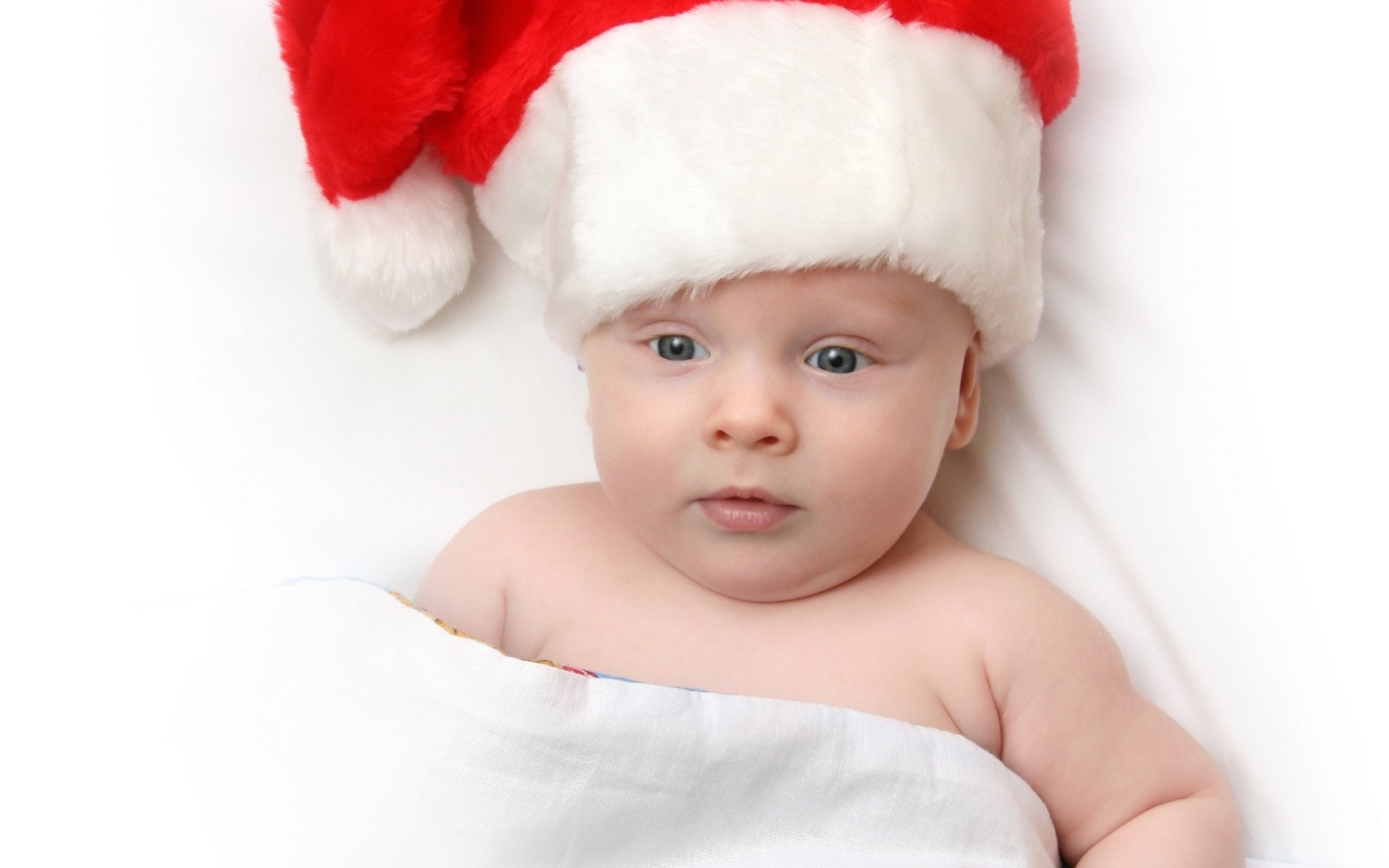 A small child in a Santa Claus hat