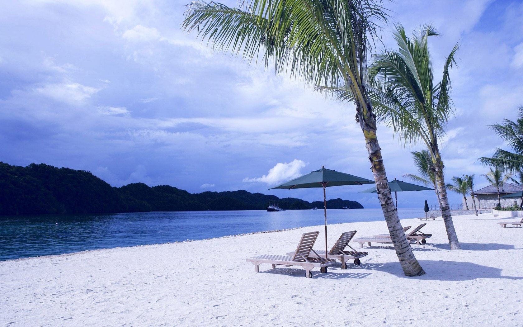 Chaise longue on a white beach in a tropical island