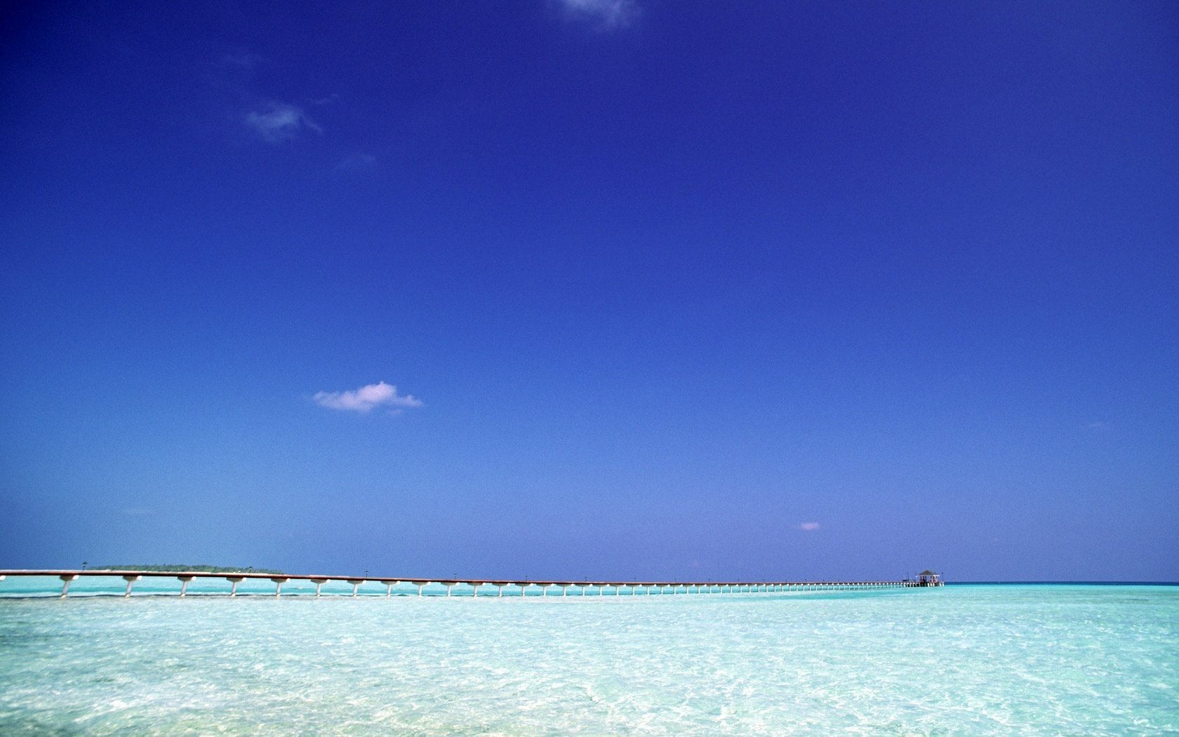 A long wooden path through the paradise of the blue ocean