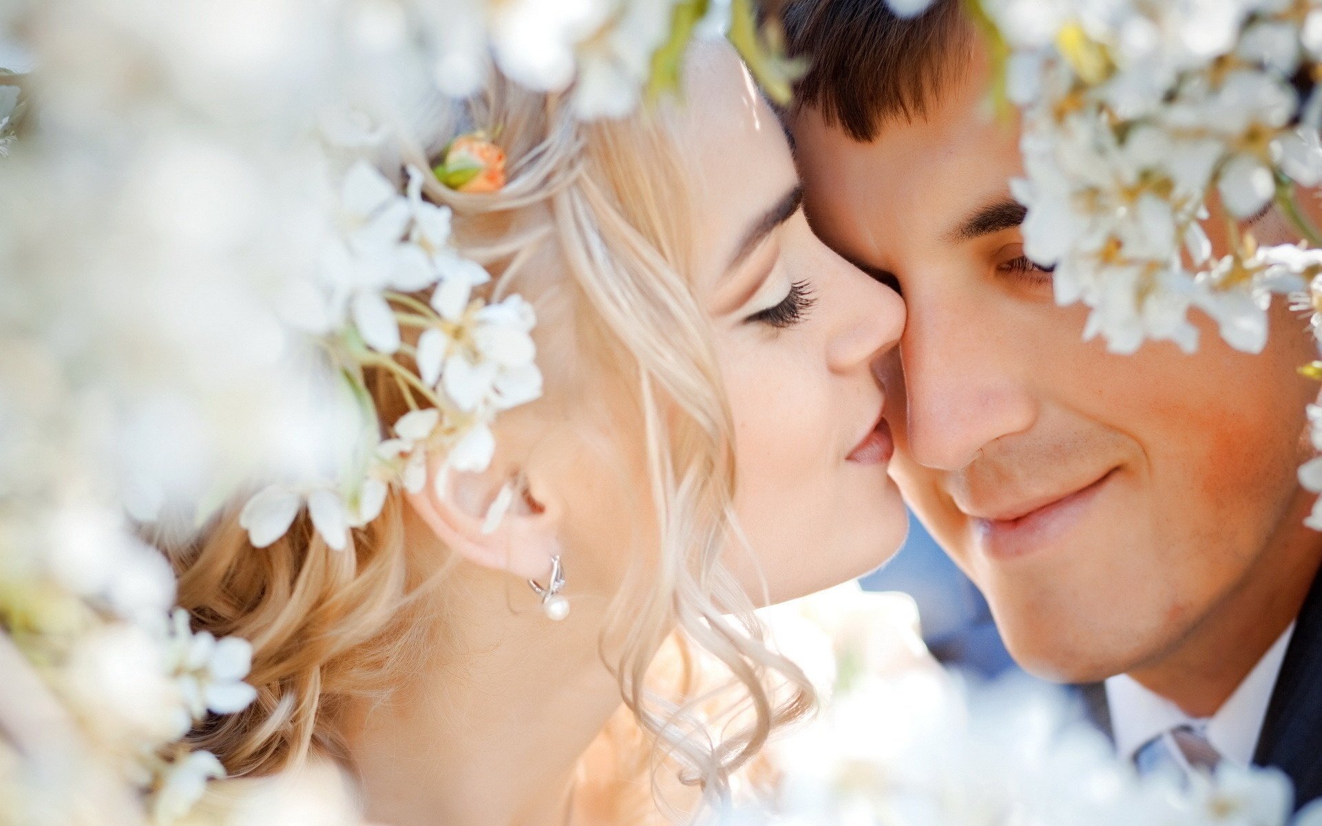 Romantic newlyweds on a background of flowers