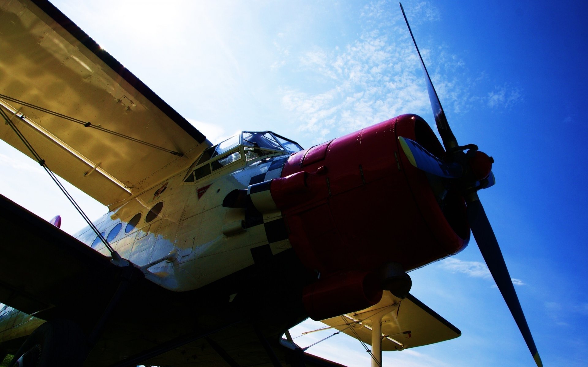 An airplane flies over the blue sky