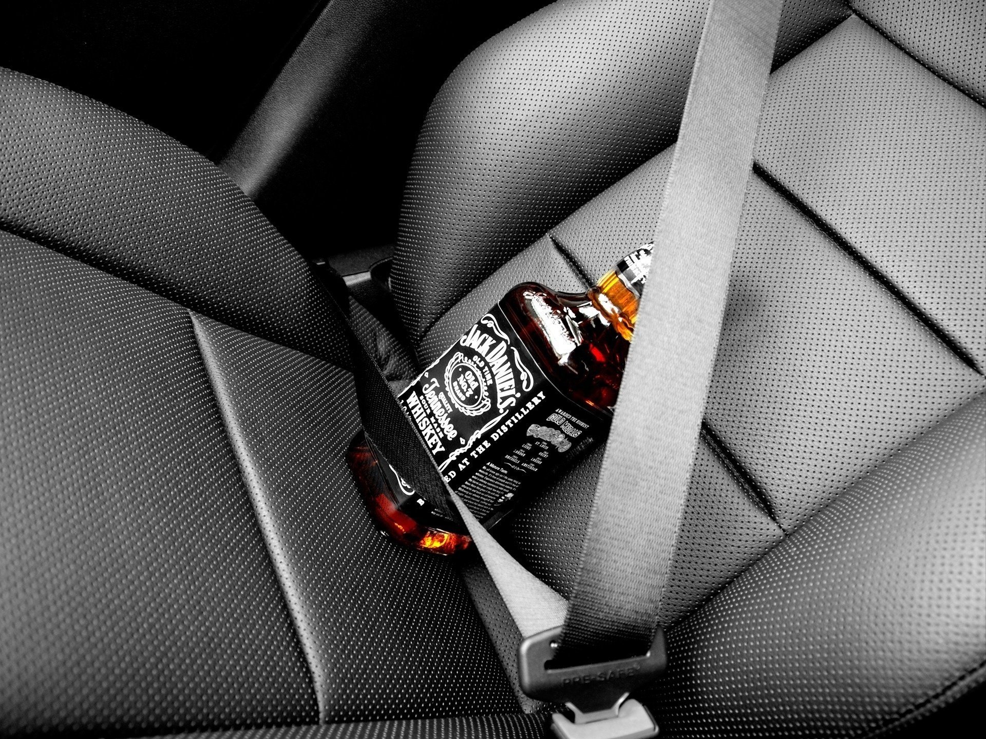 Jack Daniels bottle strapped on the seat