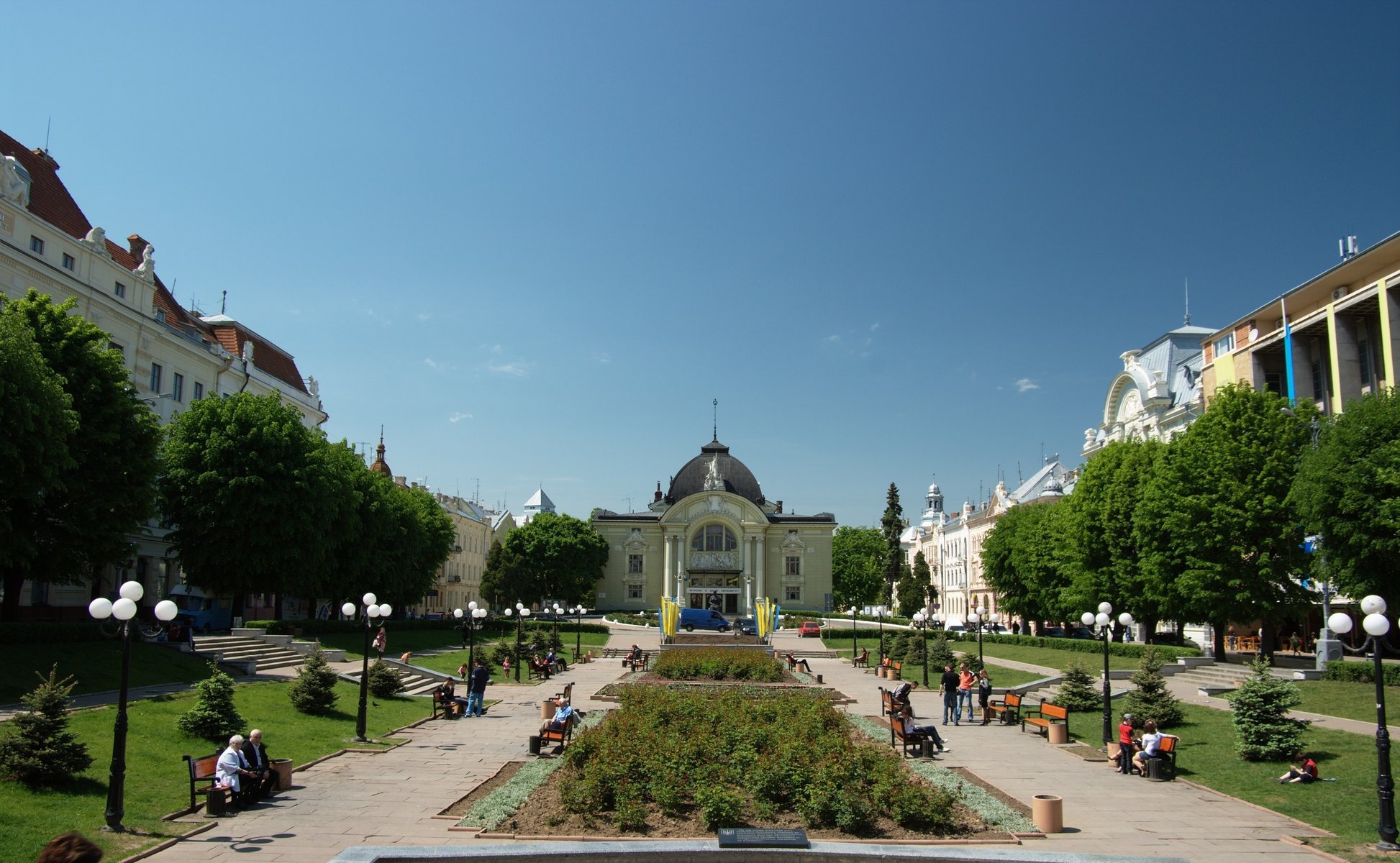 Alley in front of the theater with large flower beds