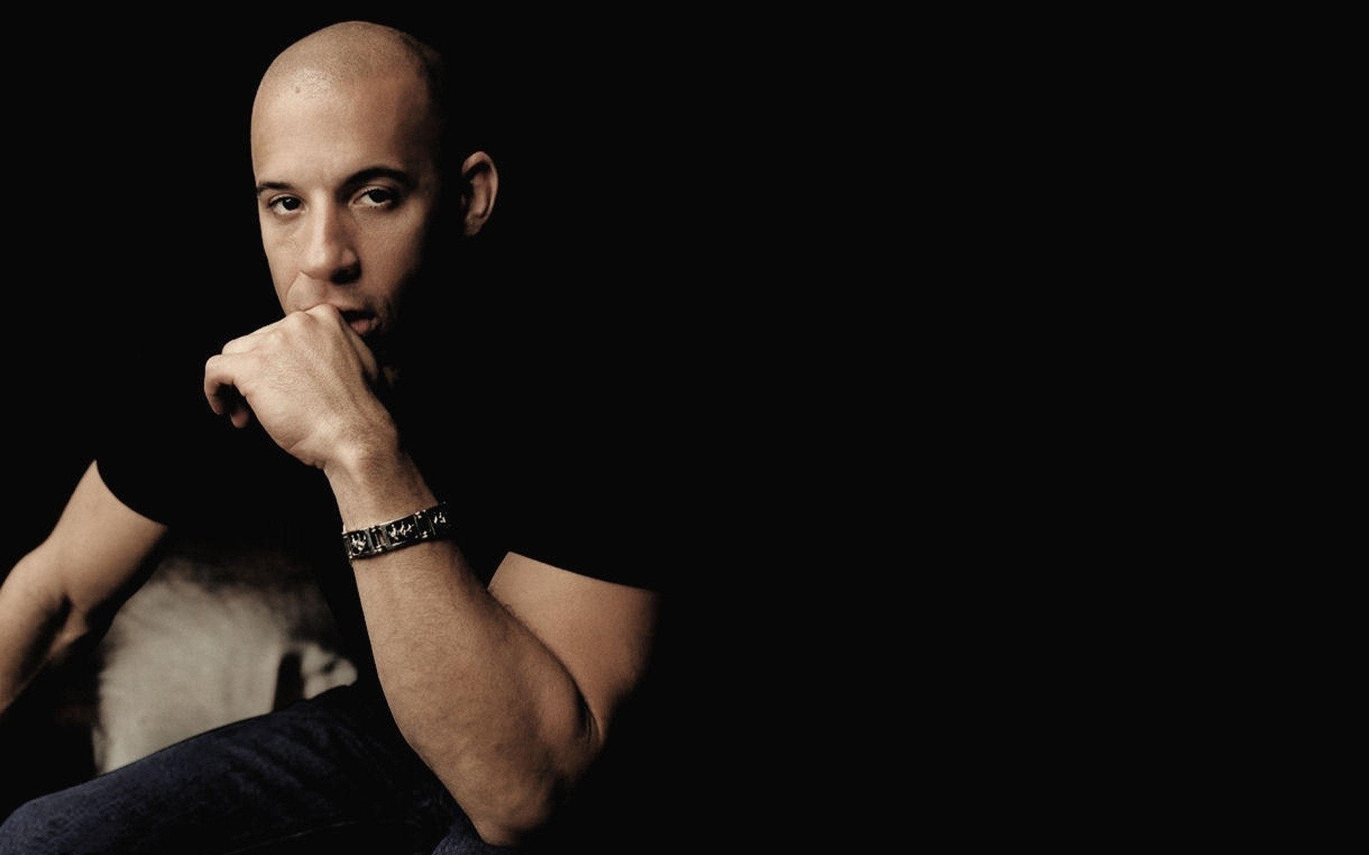 Vin Diesel with a bracelet on his arm in the dark