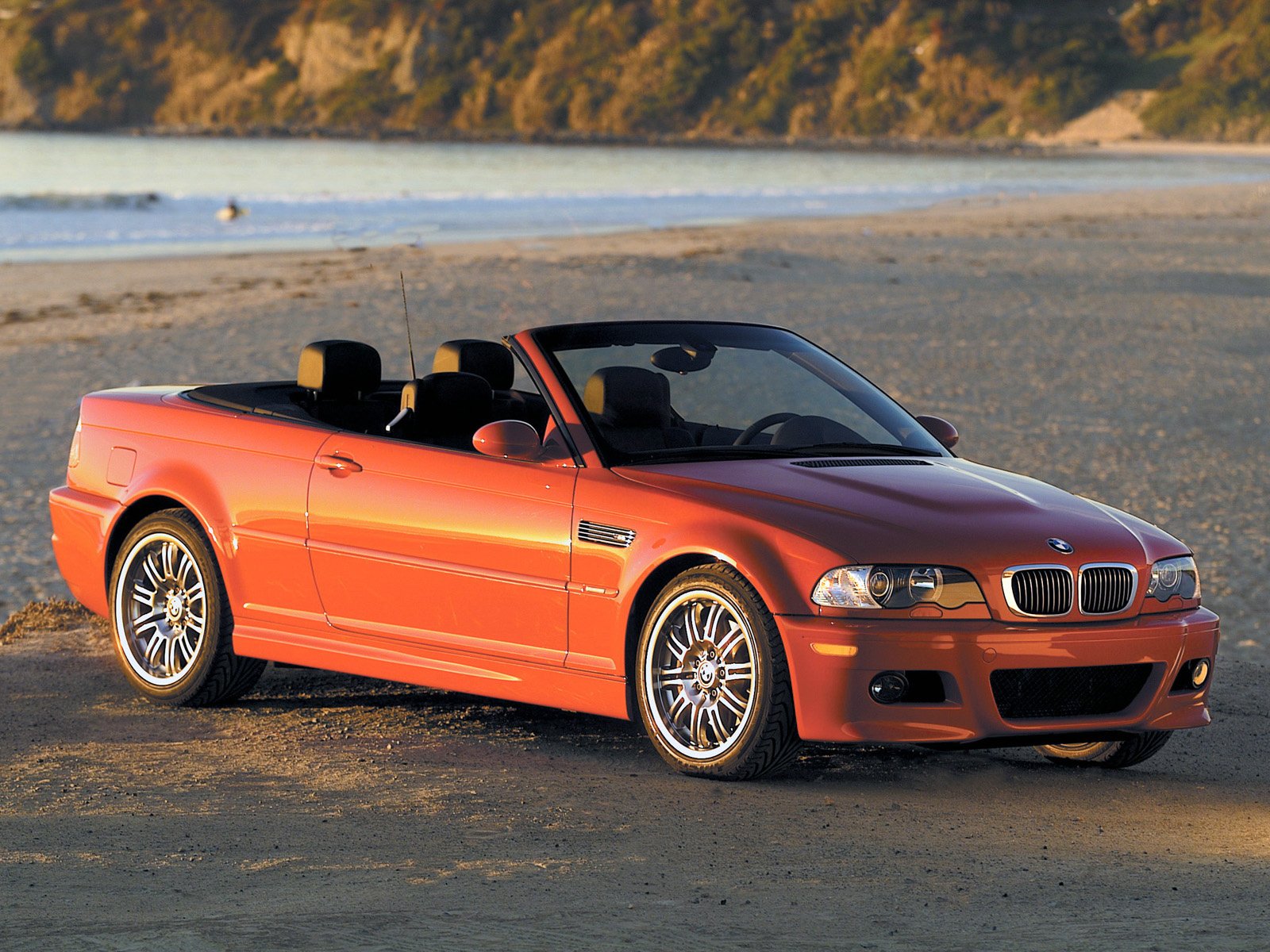 Red bmw e46 convertible on the shore in profile