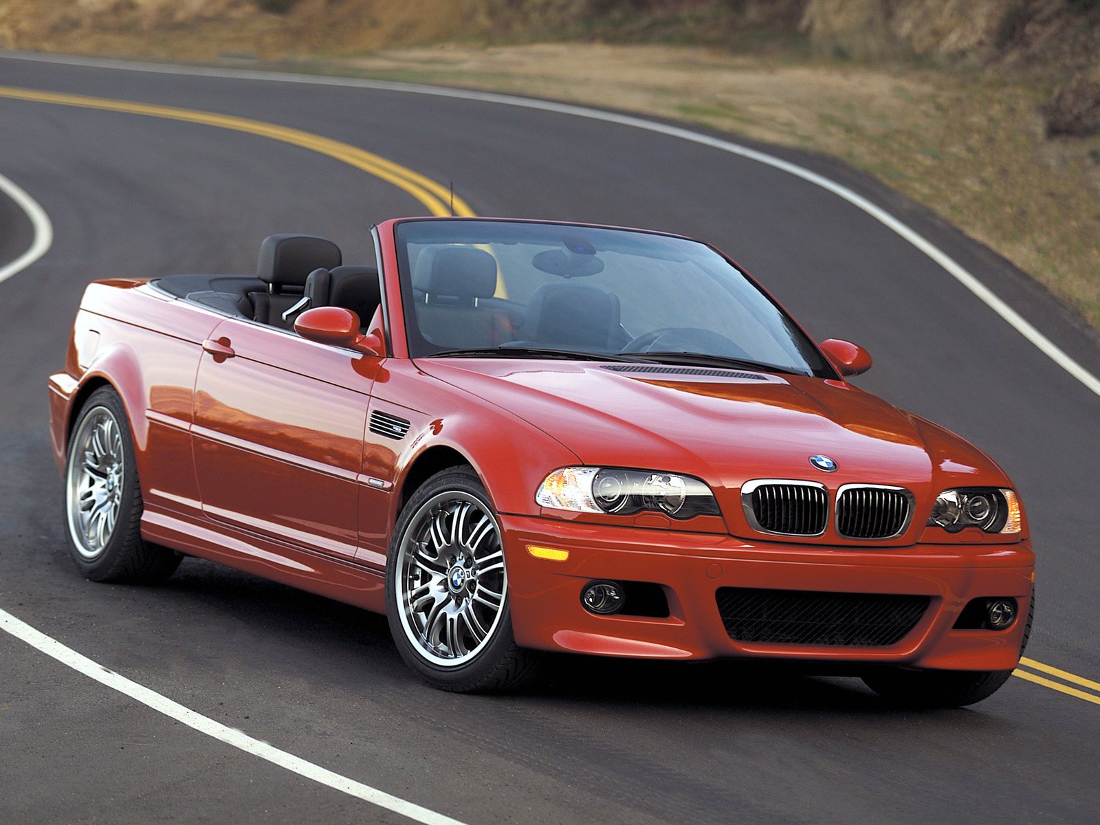 Red bmw e46 convertible on the road in motion