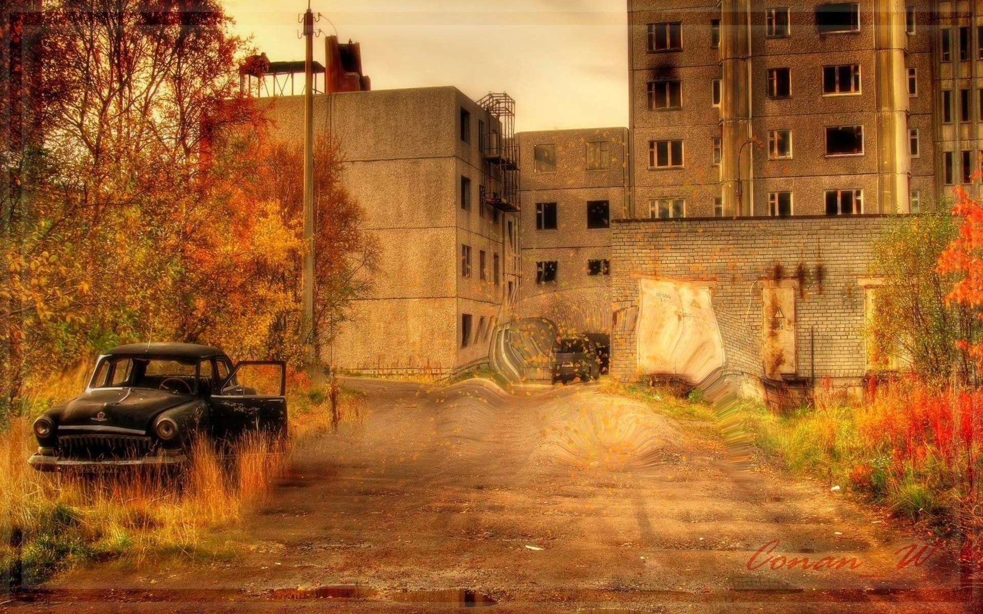 An abandoned car on the background of an autumn ghost town