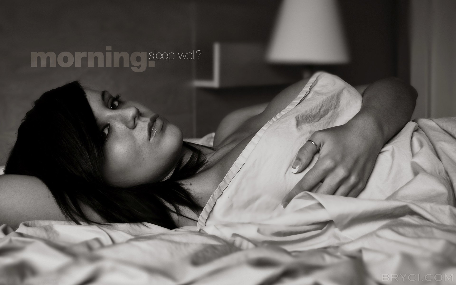 A girl in bed covers herself with a sheet