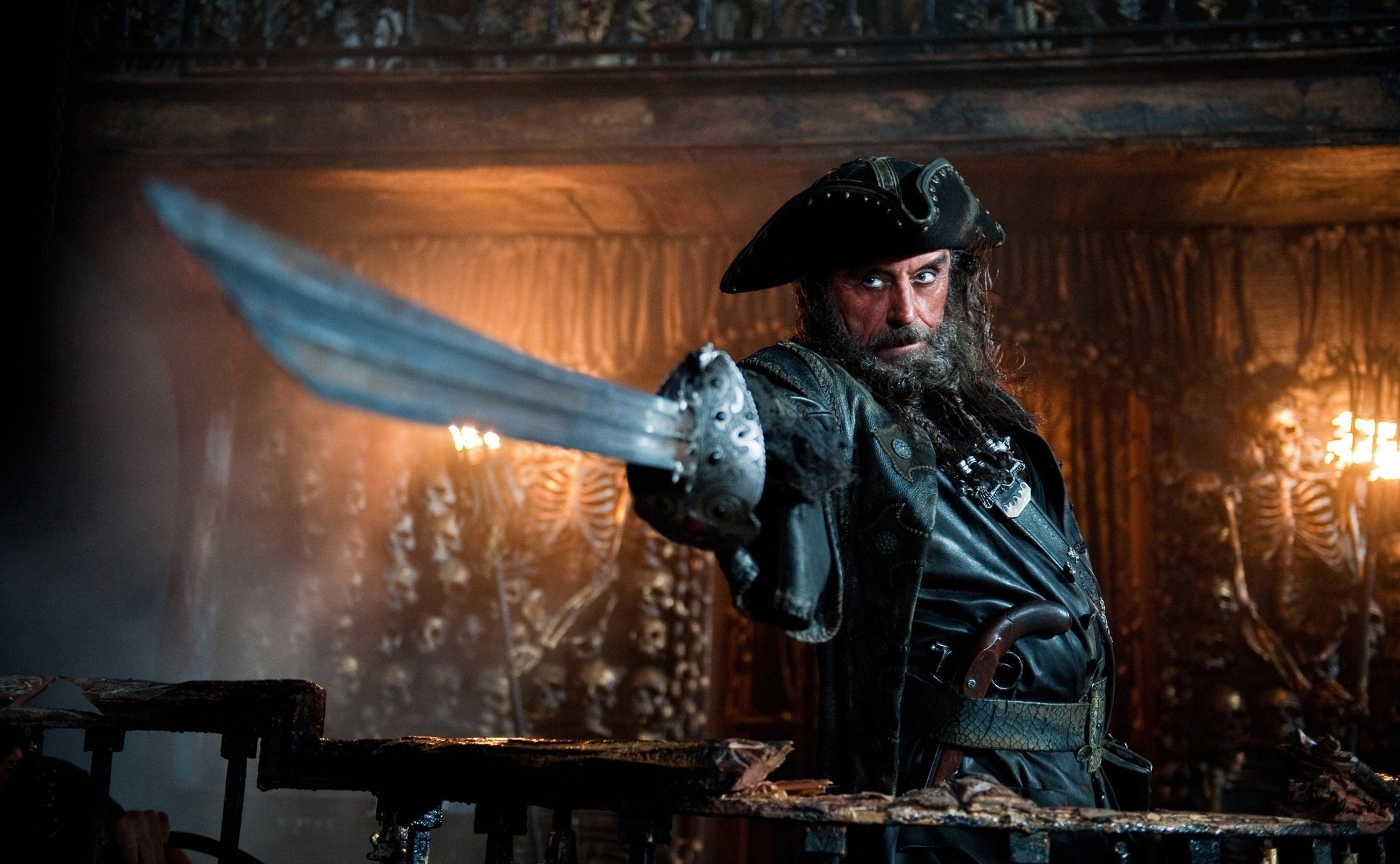 A menacing pirate with a sword on a background of bones