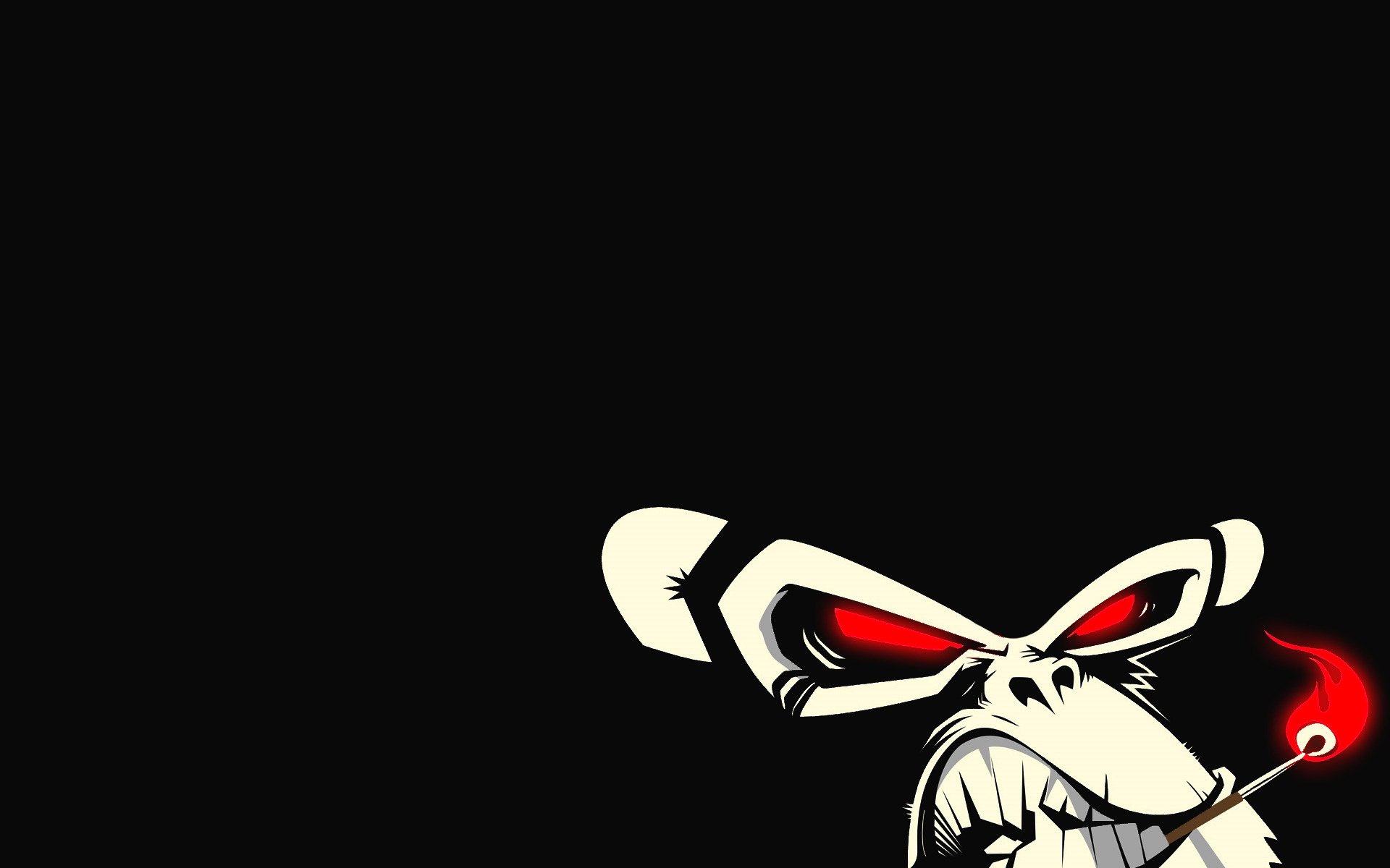 Angry macaque with a burning match in his teeth