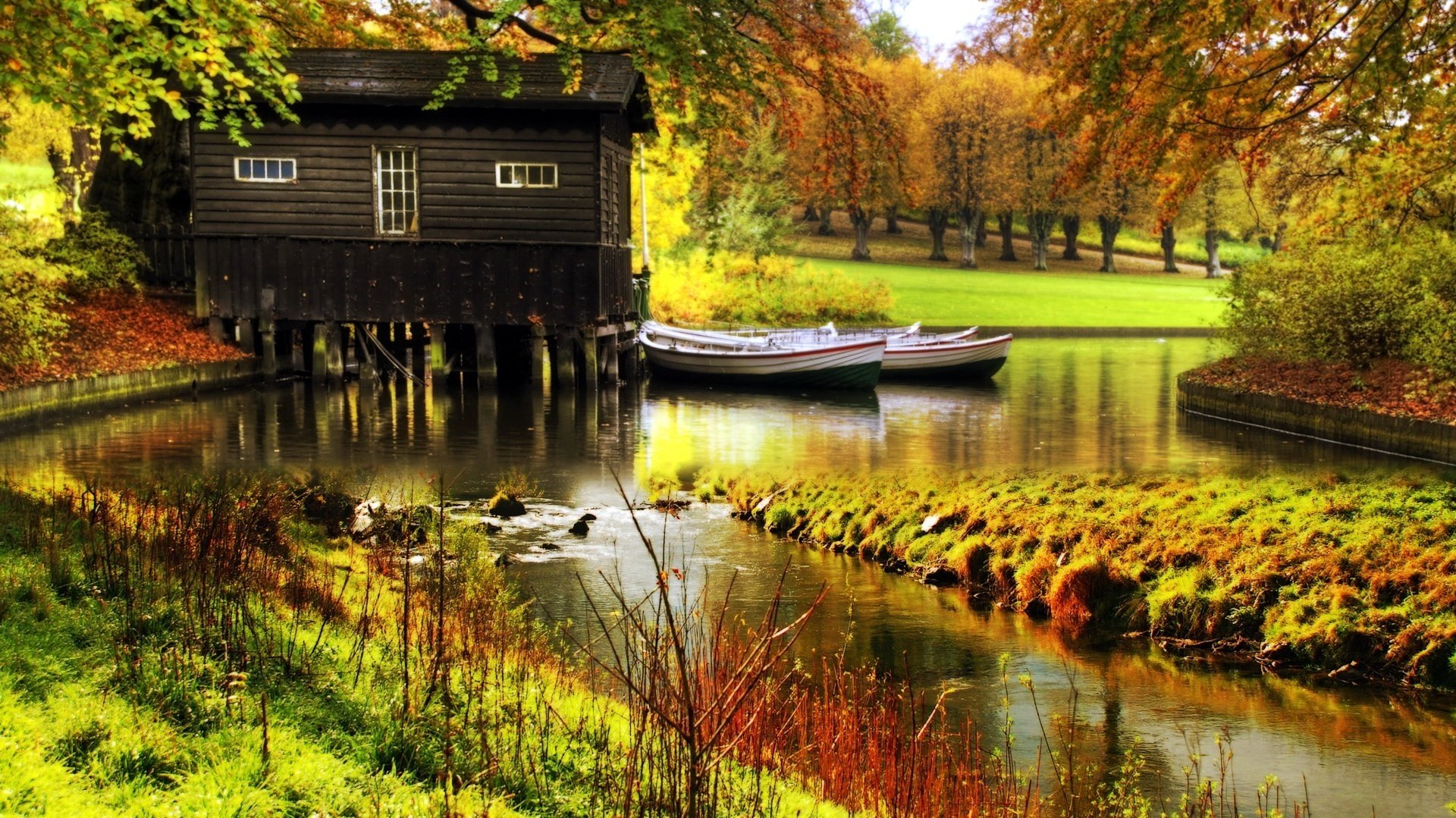 Bright autumn with a house by the water and boats