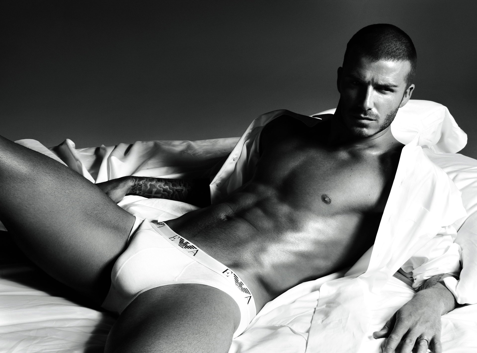A half-naked David Beckham in a white shirt