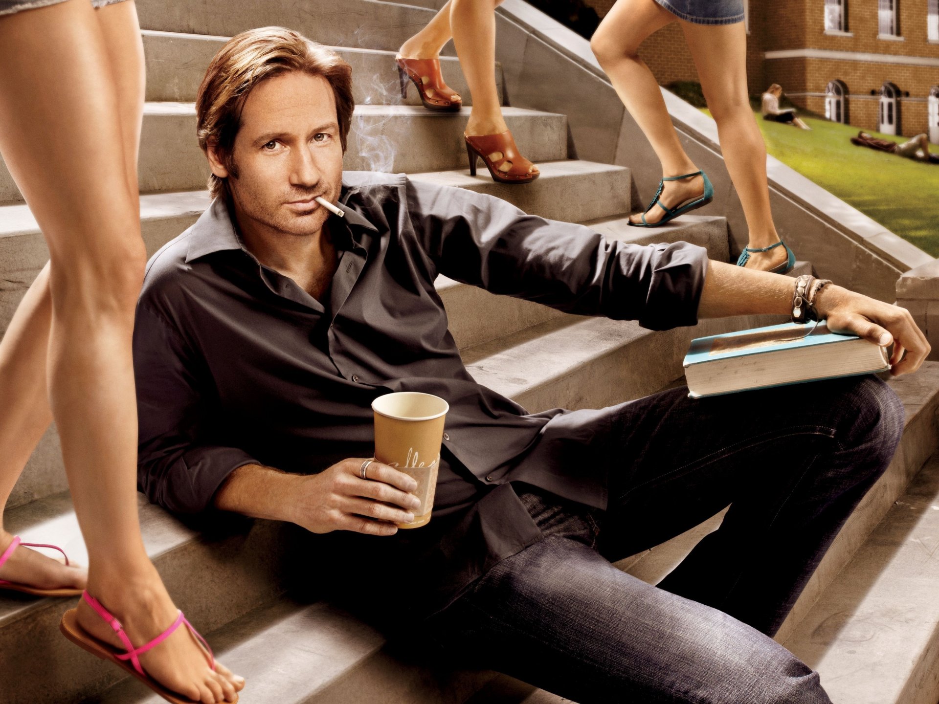 David Duchovny on the steps of the stairs among beautiful female legs. David Duchovny with a book and coffee in his hands