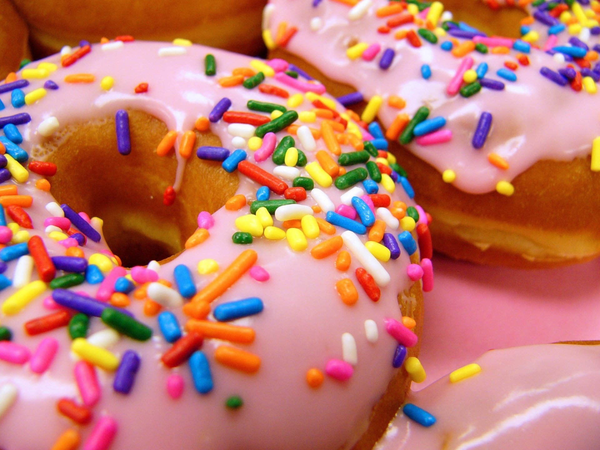 Donuts in pink glaze and with colored sprinkles