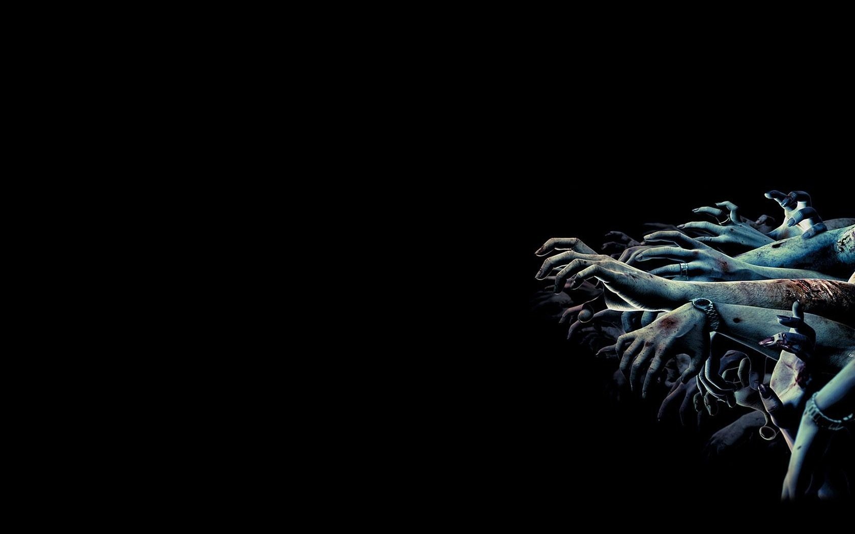 On a black background, a huge number of dead people's hands