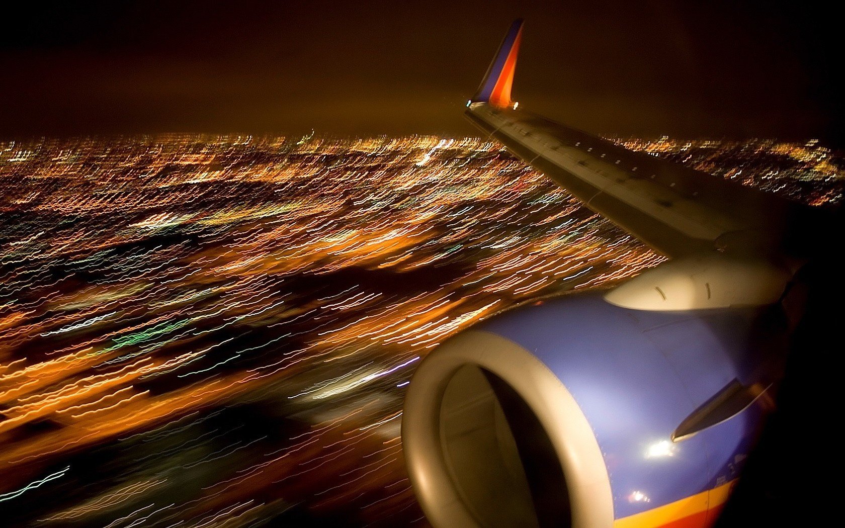 View from the porthole of the airplane wing and city lights