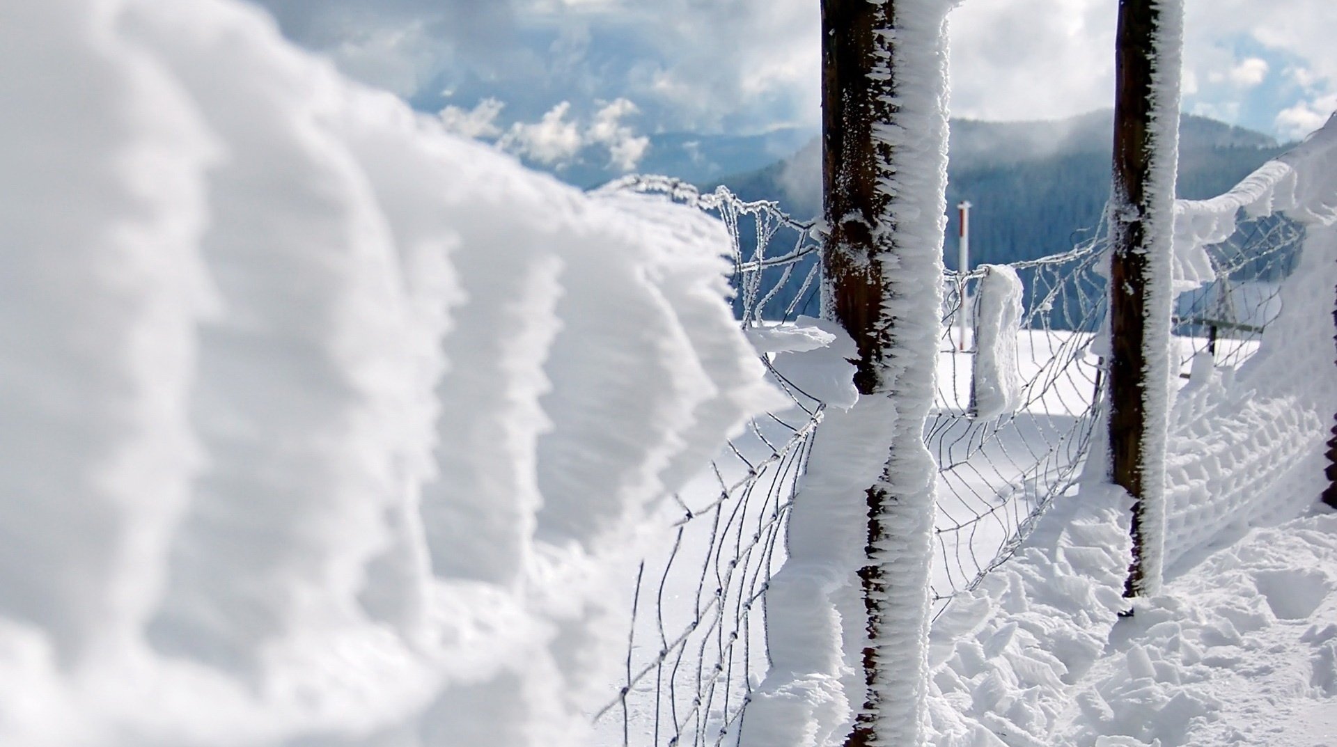 Snow fence on the background of winter mountains