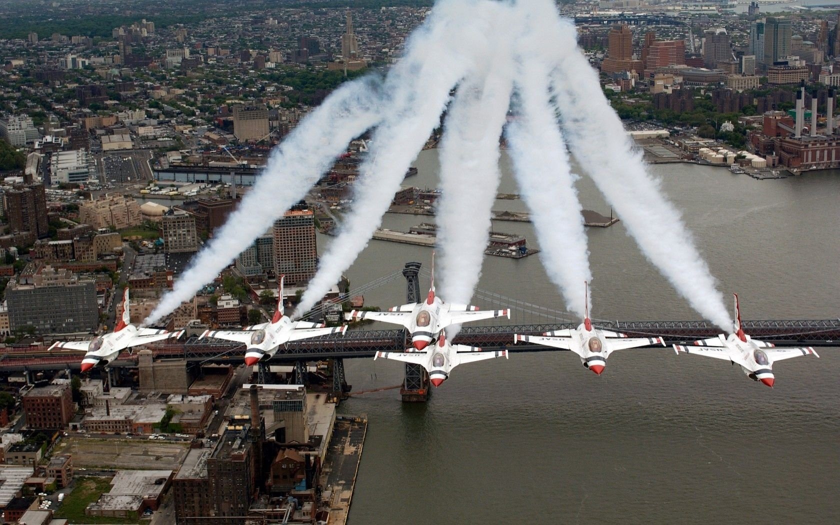 Airshow over the city. The planes made a figure with a plume of smoke