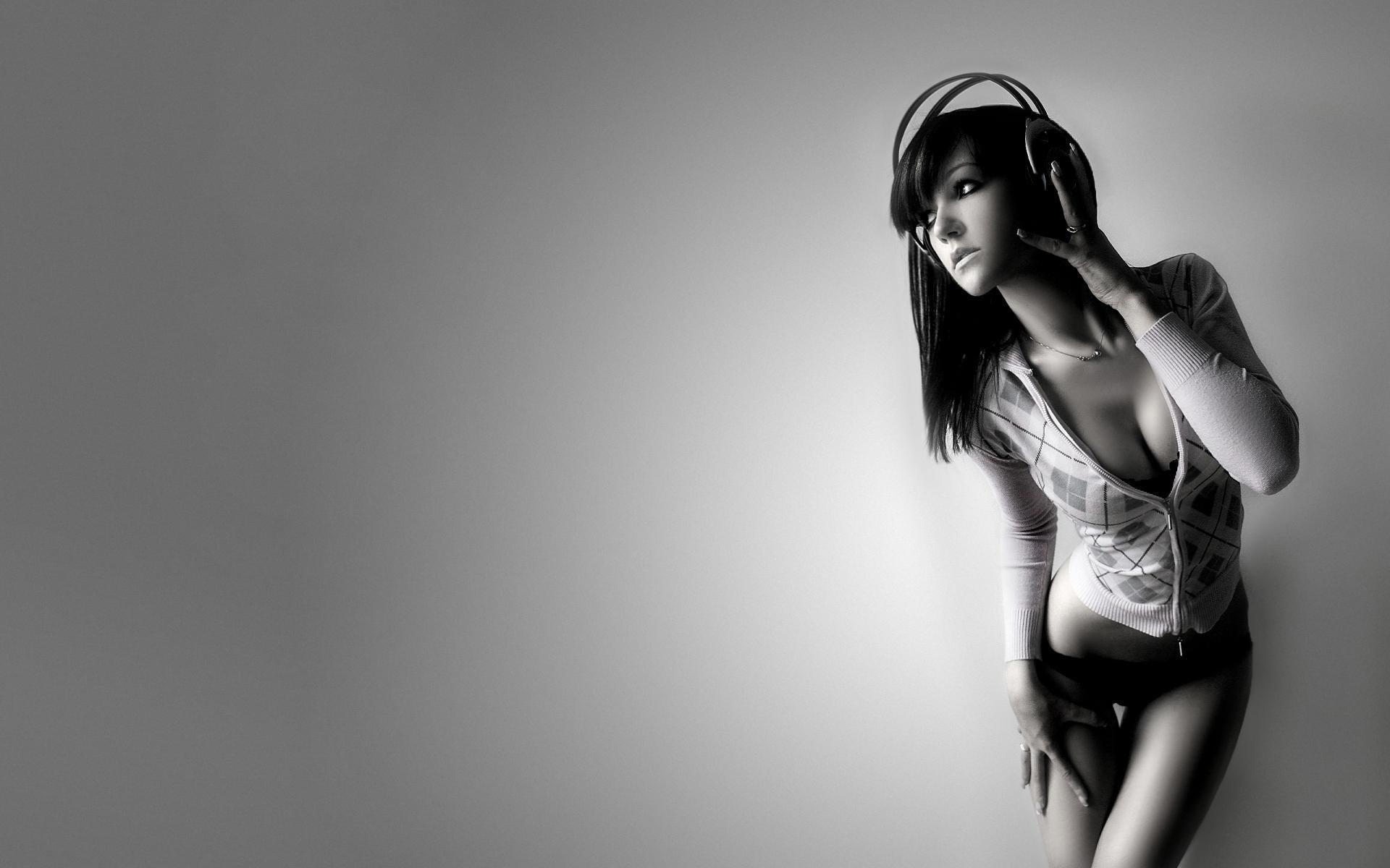 Young sexy girl in headphones. Black and white image