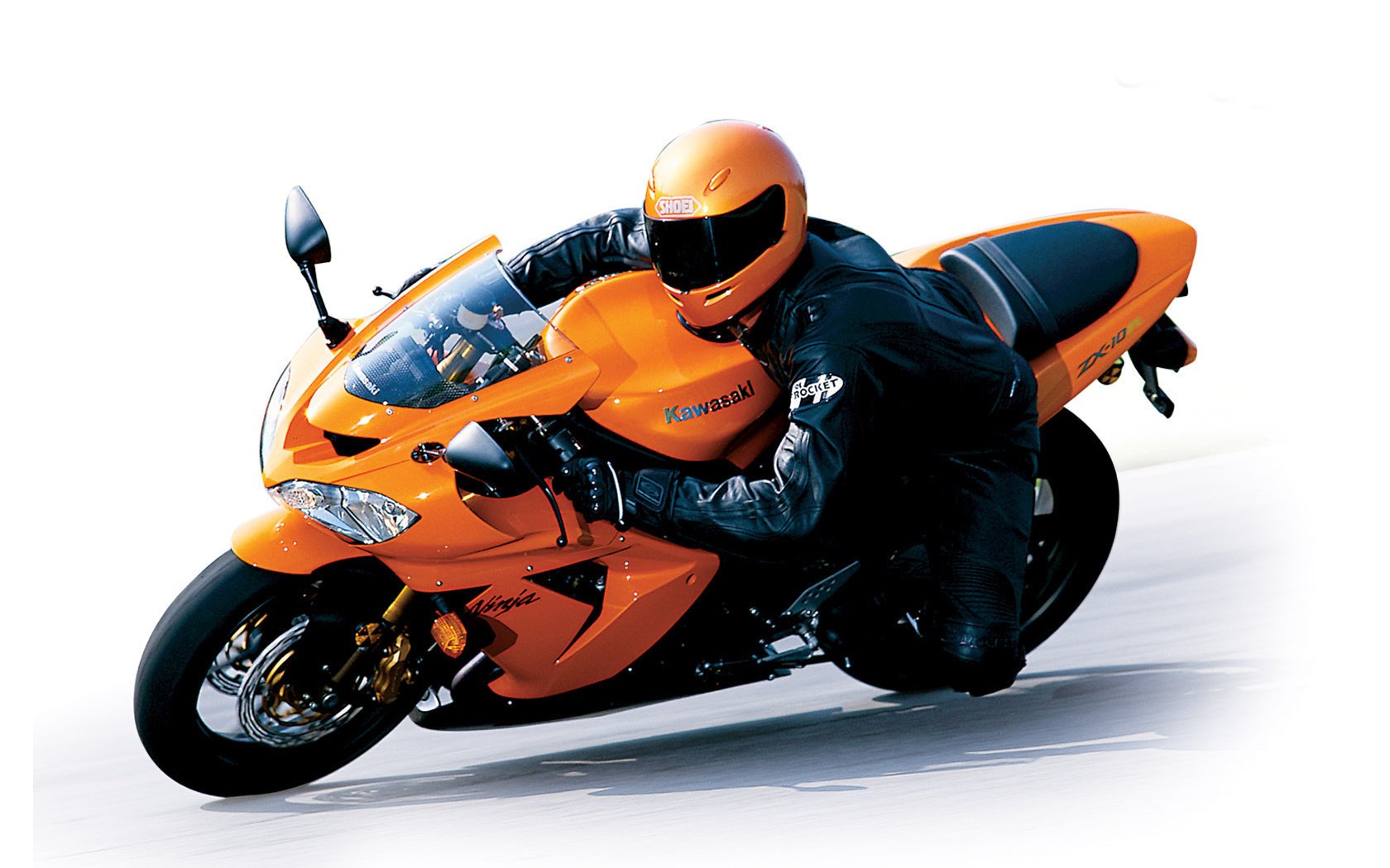 Helmeted pilot on an orange kawasaki zx-10r motorcycle