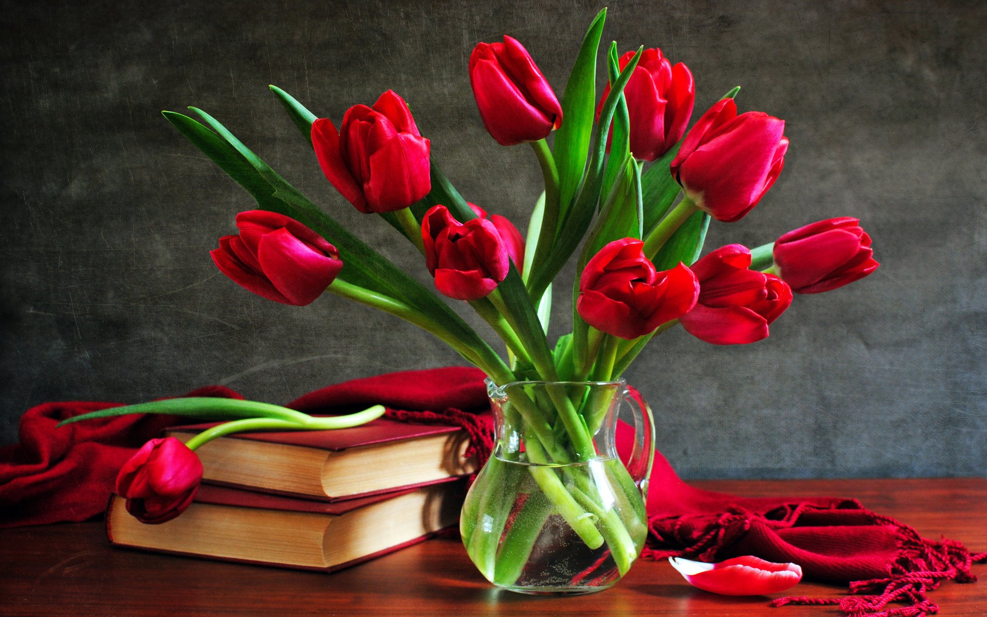 A bouquet of tulips in a vase near the book