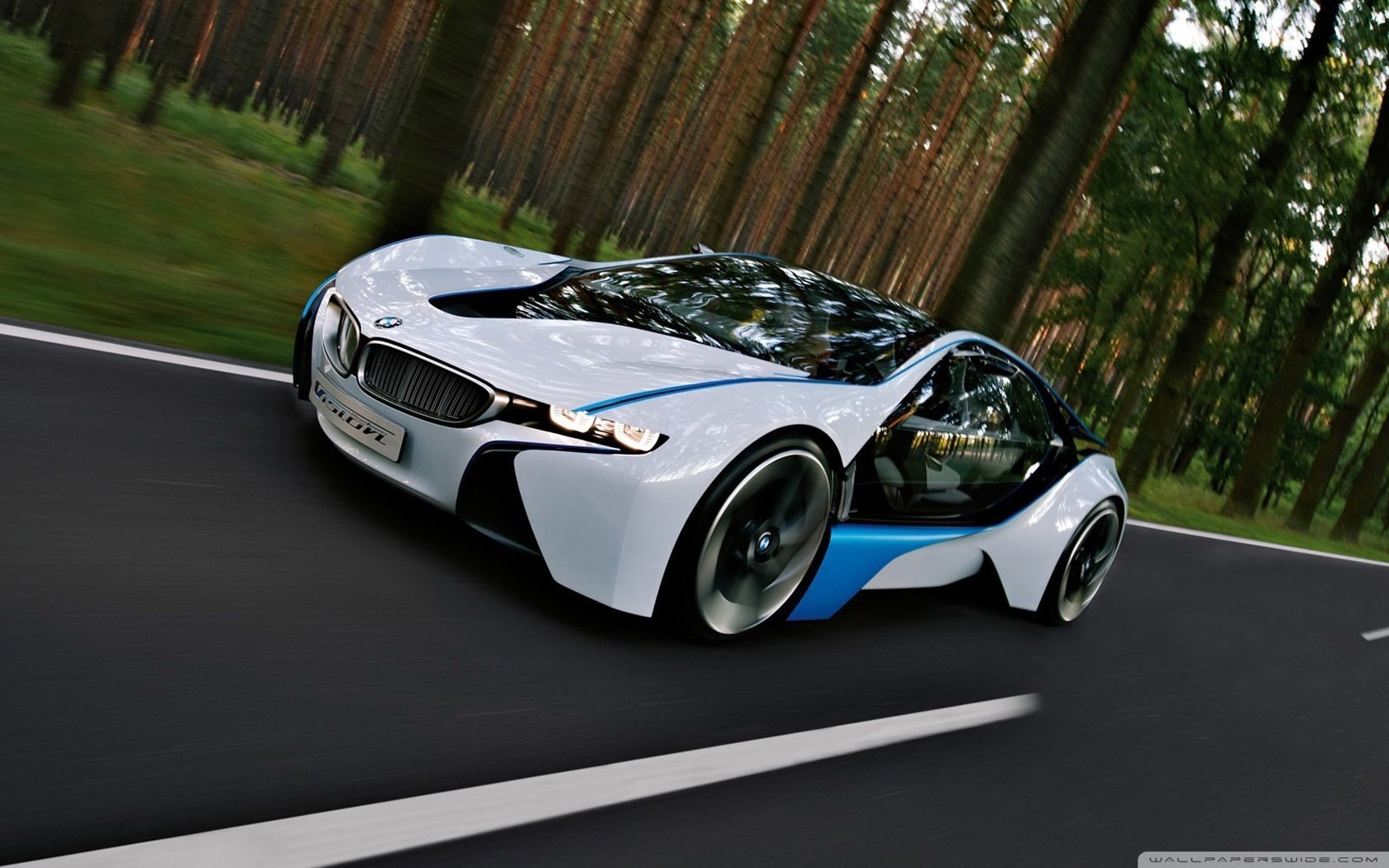 A white electric car rides on perfect asphalt