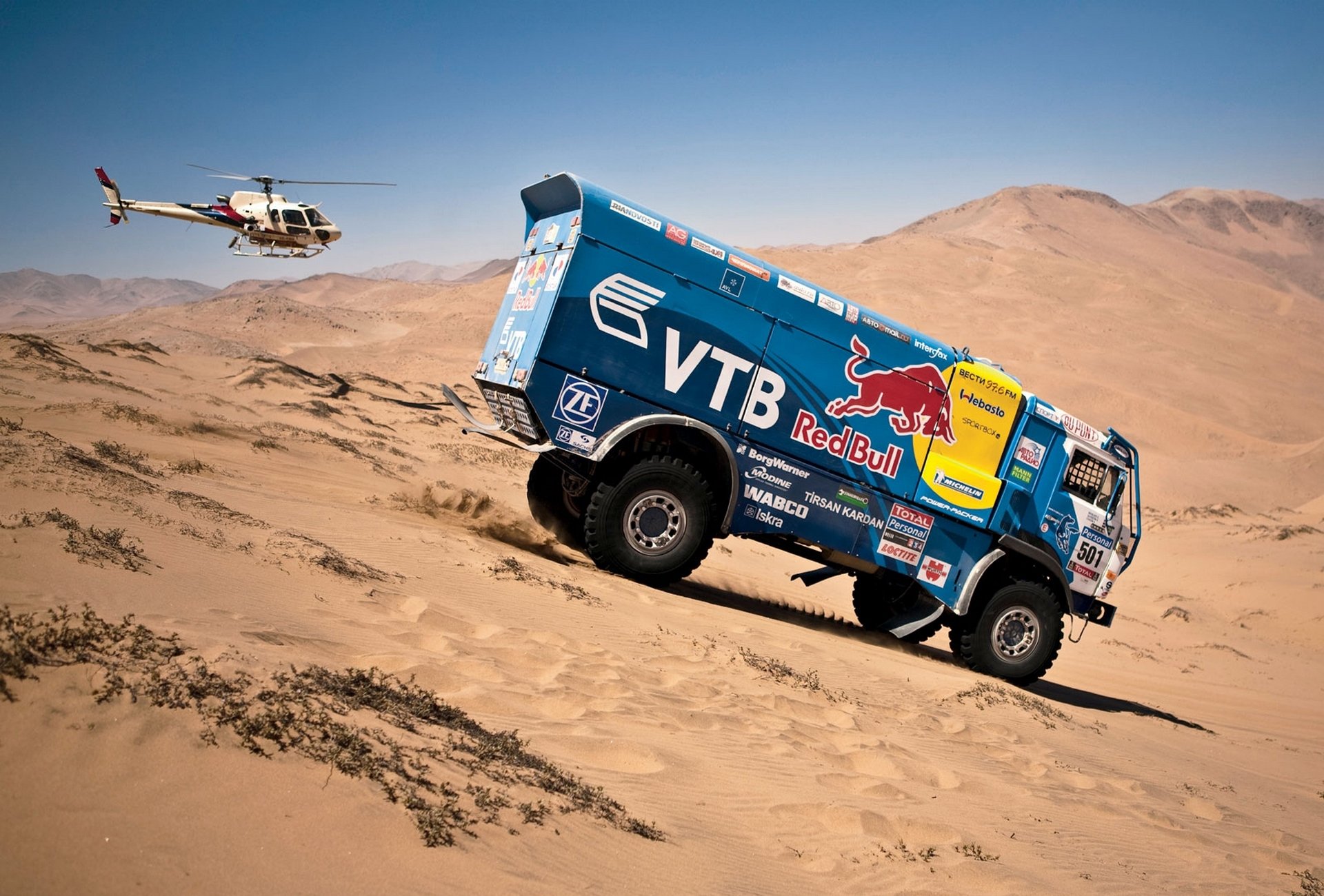 kamaz to dakar dakar rally blue red bull helicopters a side view descent machine car sand dune