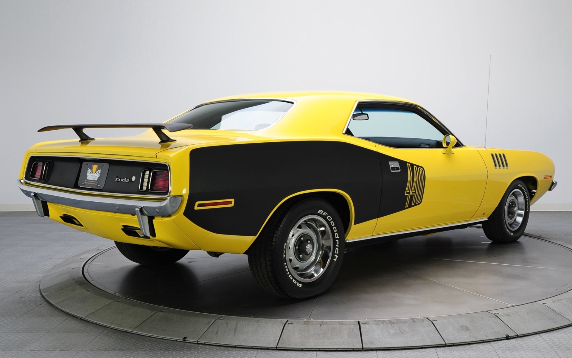 plymouth cuda 1971 where barracuda rear view muscle car yellow background