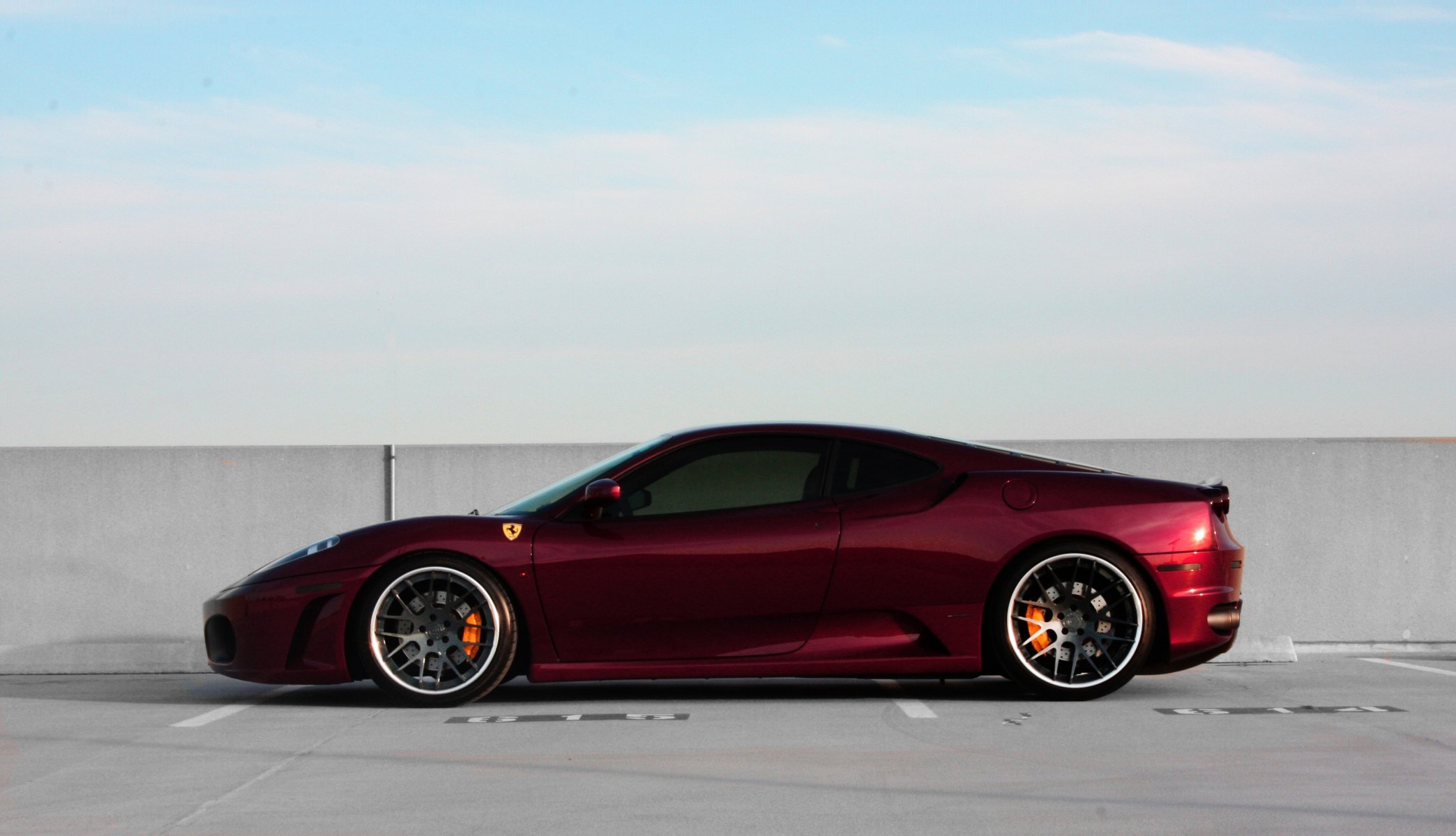 ferrari f430 red wheels black dark red section drives wall sky