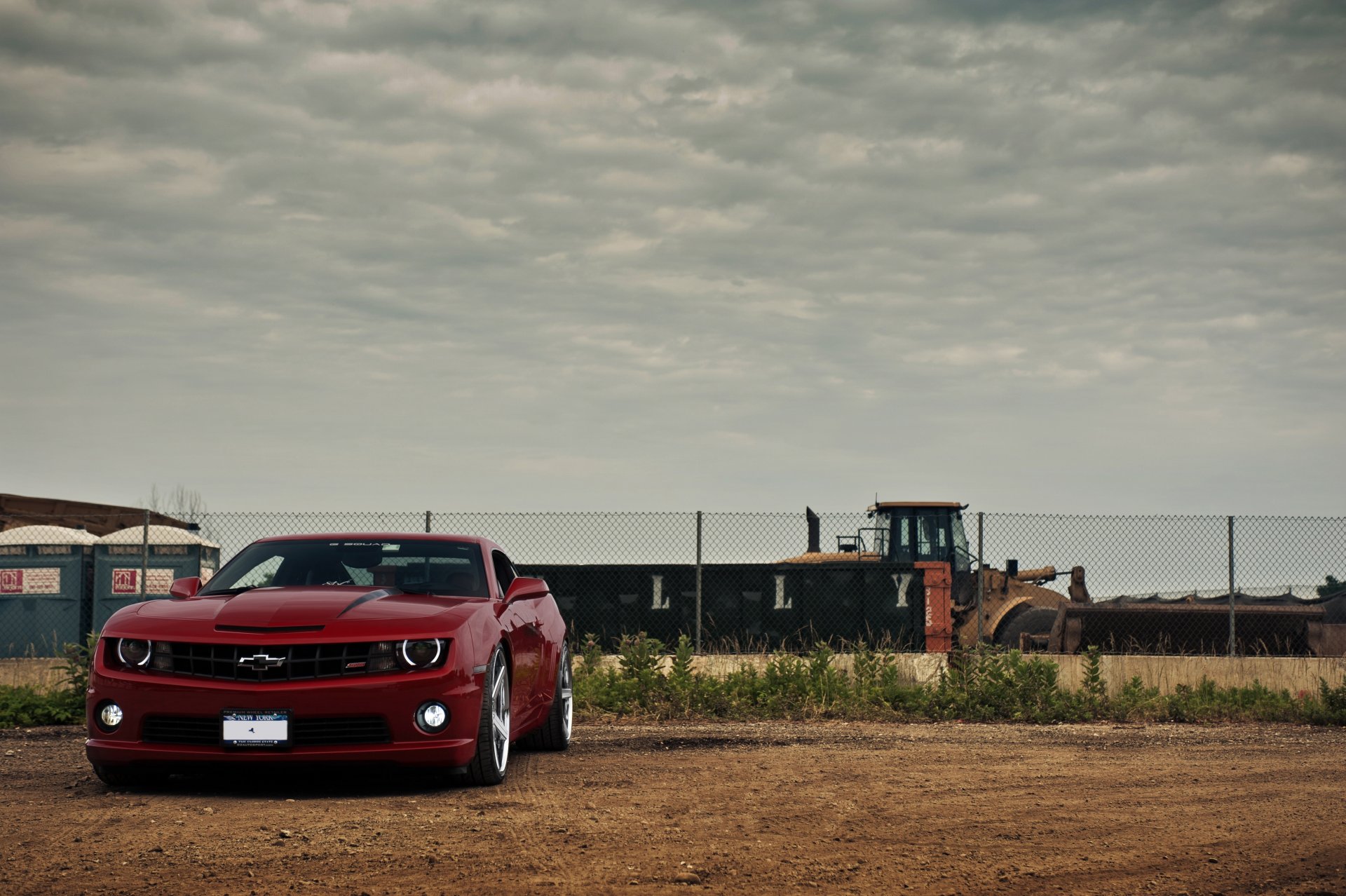 chevrolet camaro ss red view fencing bulldozer sky clouds