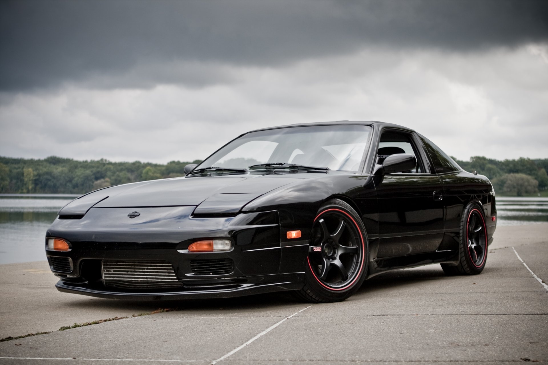 nissan 240sx wheels black x 240c drives sky clouds lake tree