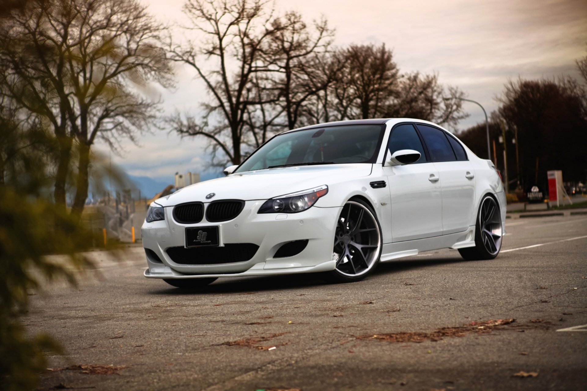 bmw m5 e60 white parking sedan coloured autumn leaves asphalt of the strip