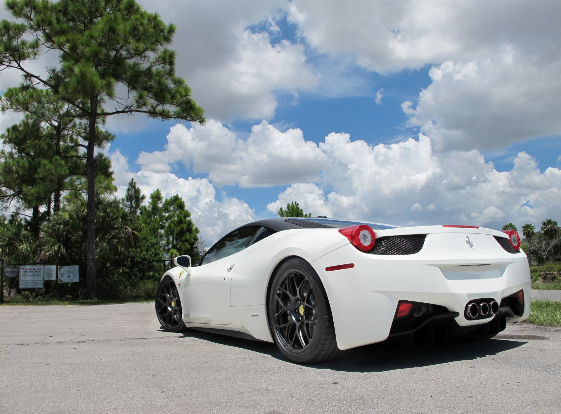 ferrari 458 italia white black wheels sky italy drives rear view clouds tree fencing black roof