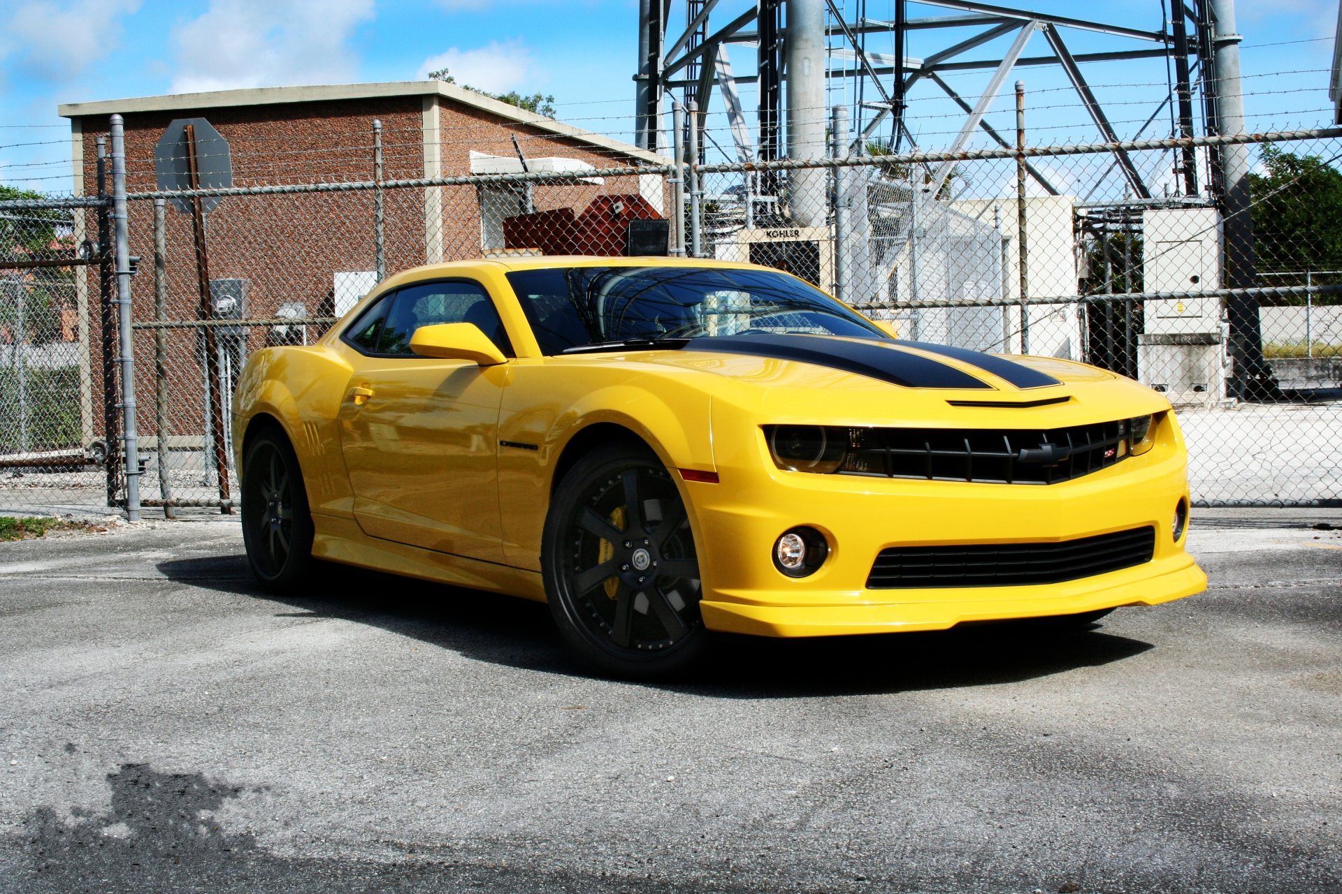 chevrolet camaro ss yellow wheels sky clouds fencing the tower truck
