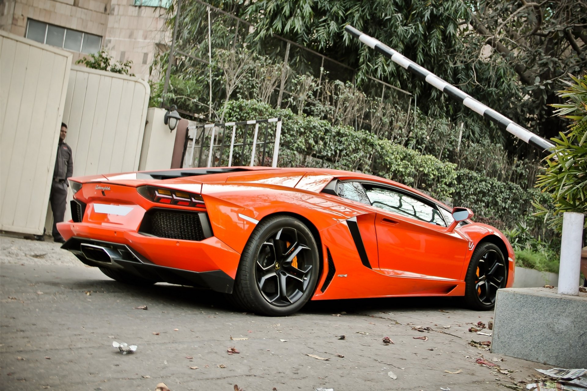lamborghini aventador lp700-4 orange a side view fencing tree gates