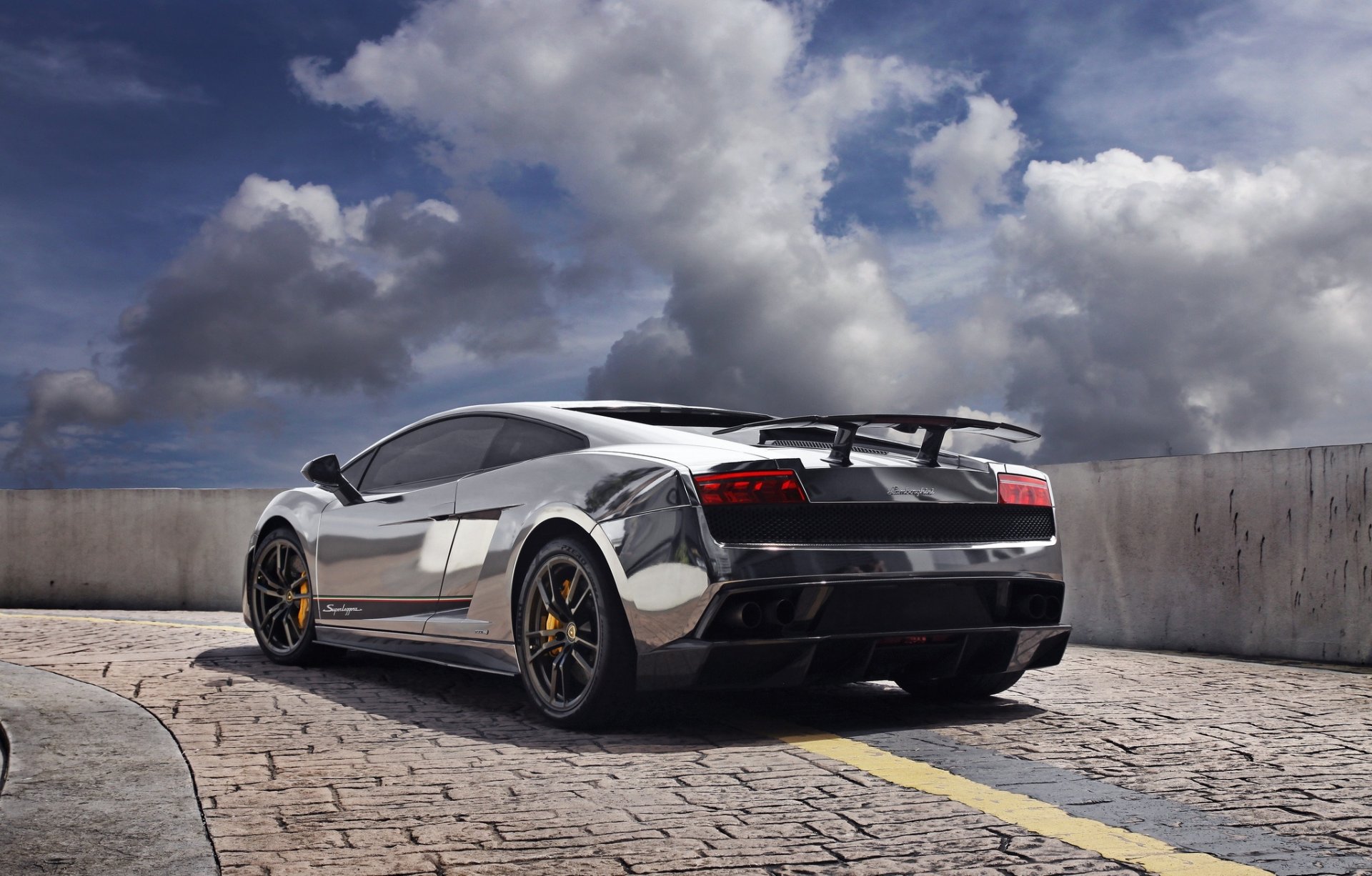 lamborghini gallardo lp570-4 superleggera silvery back of silver fencing shadow paving sky clouds