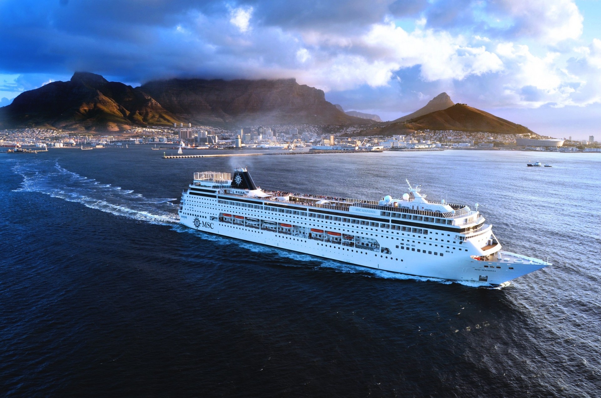 ship sky msc town on the fly passenger sea symphony day mountain white