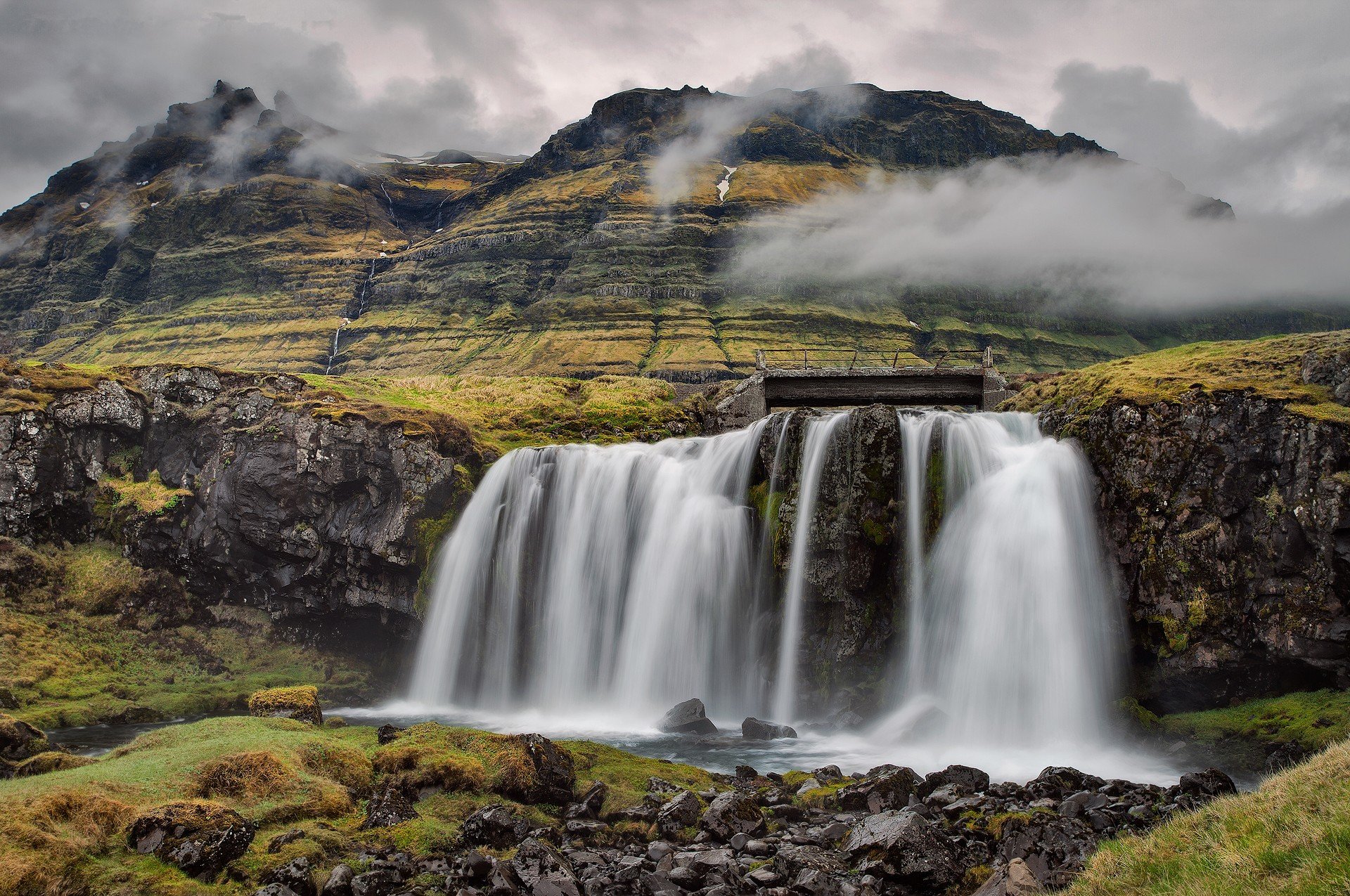kirkjufell iceland sky clouds mountain waterfall stones