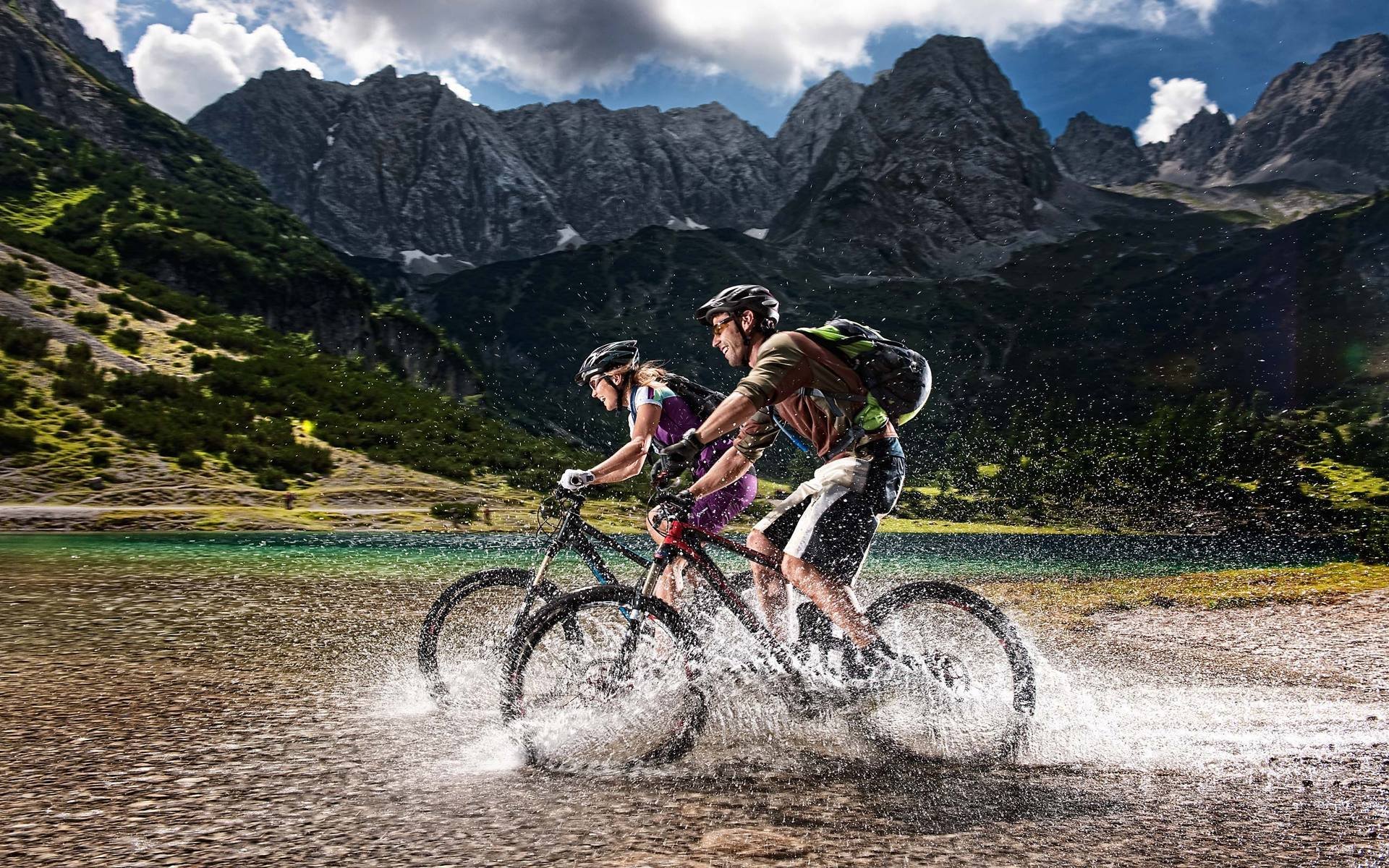 men a woman cyclists tourists mountain alps nature