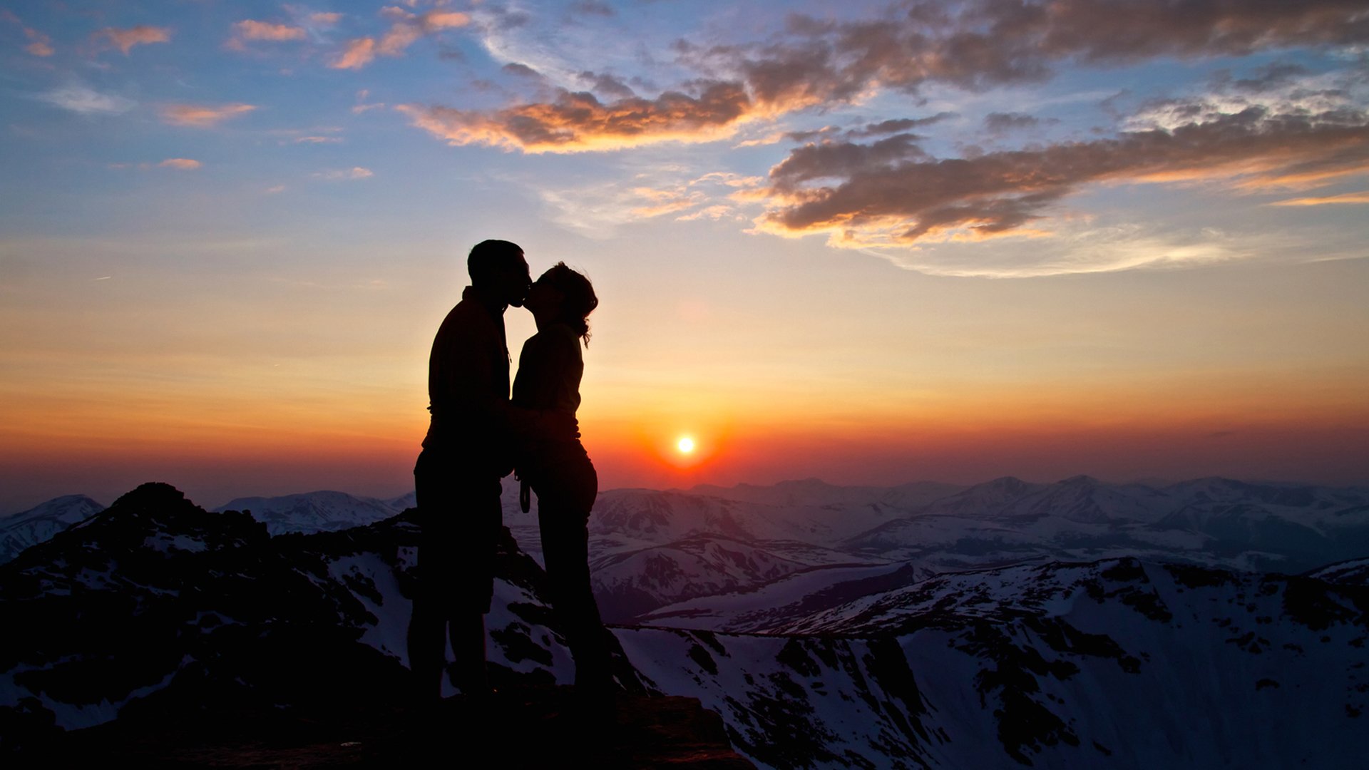 couple love kiss hug girl boy woman man sunset sun mountains snow clouds sky