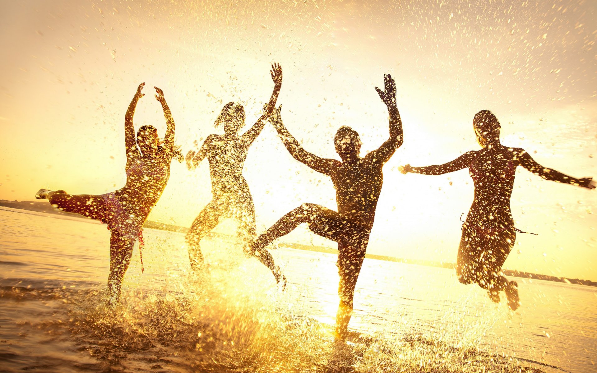 people the group summer water drops spray happiness girls jump horizon sky dawn sunset light rays silhouettes outline figures