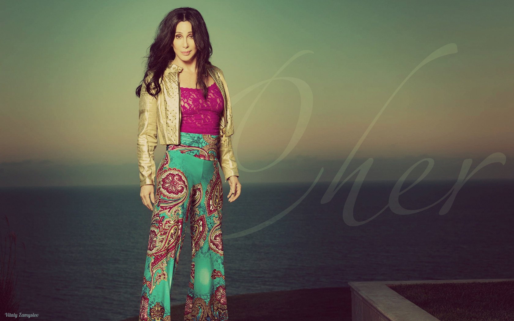 Singer Cher in a fuchsia top and sea-green bell bottoms with floral ornaments