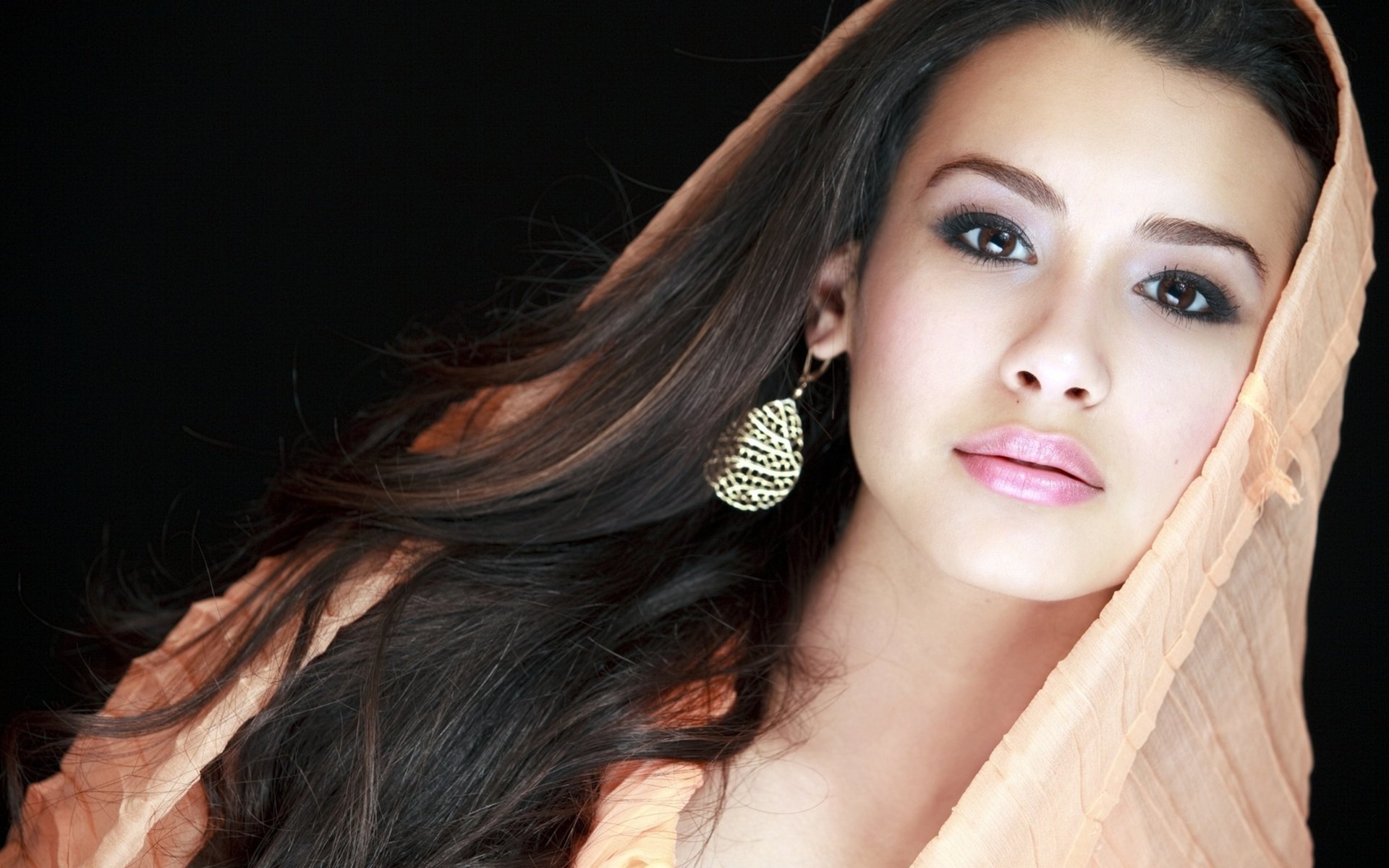 A young Asian woman in a scarf and large earrings