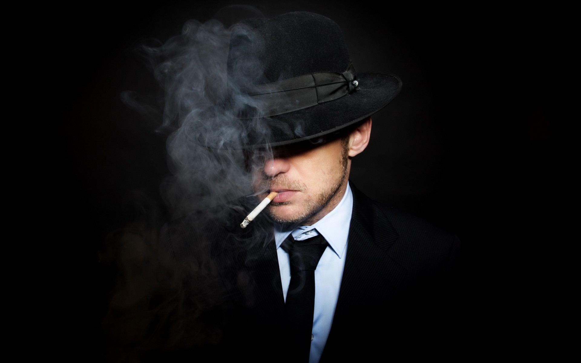 bind suit man black background smoke hat